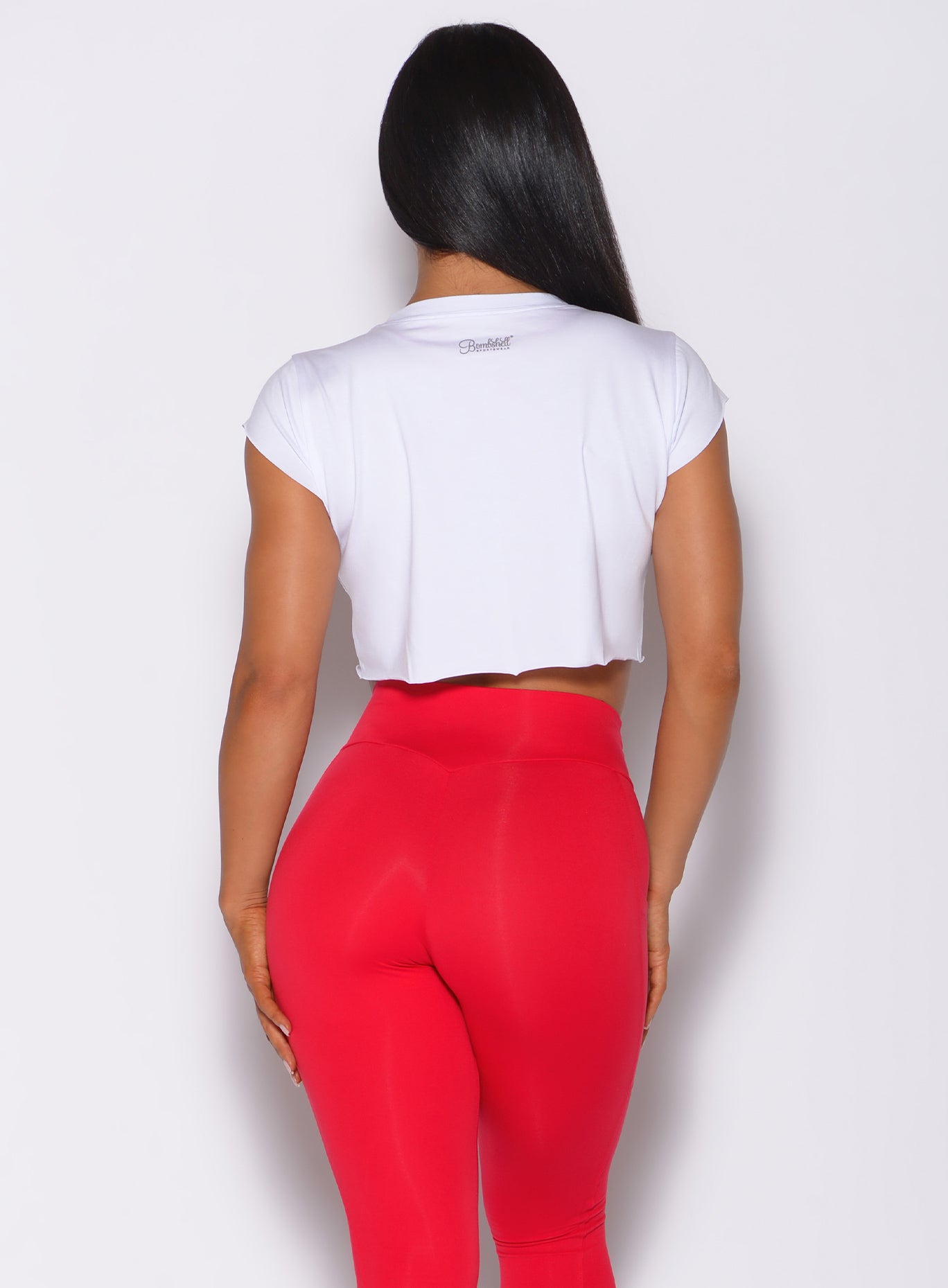 back profile profile view of a model in our white USA Barbell tee and a red leggings