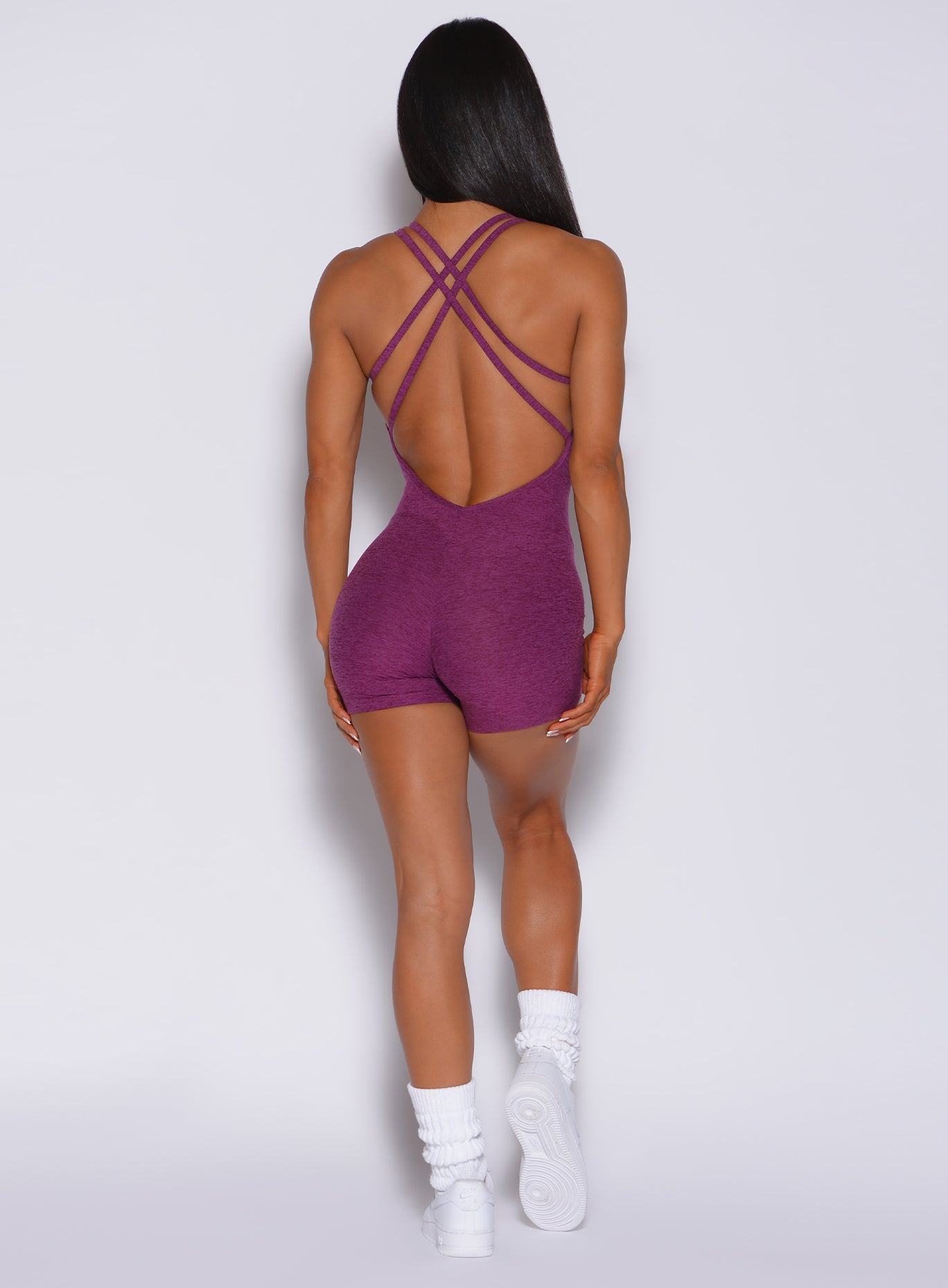 back profile view of the model in our magenta form bodysuit shorts 