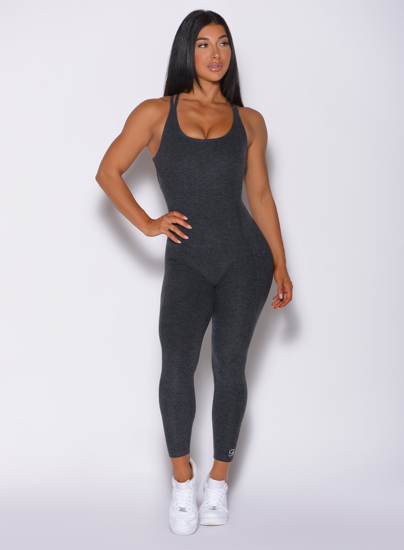 Front profile view of a model in our form bodysuit in charcoal color