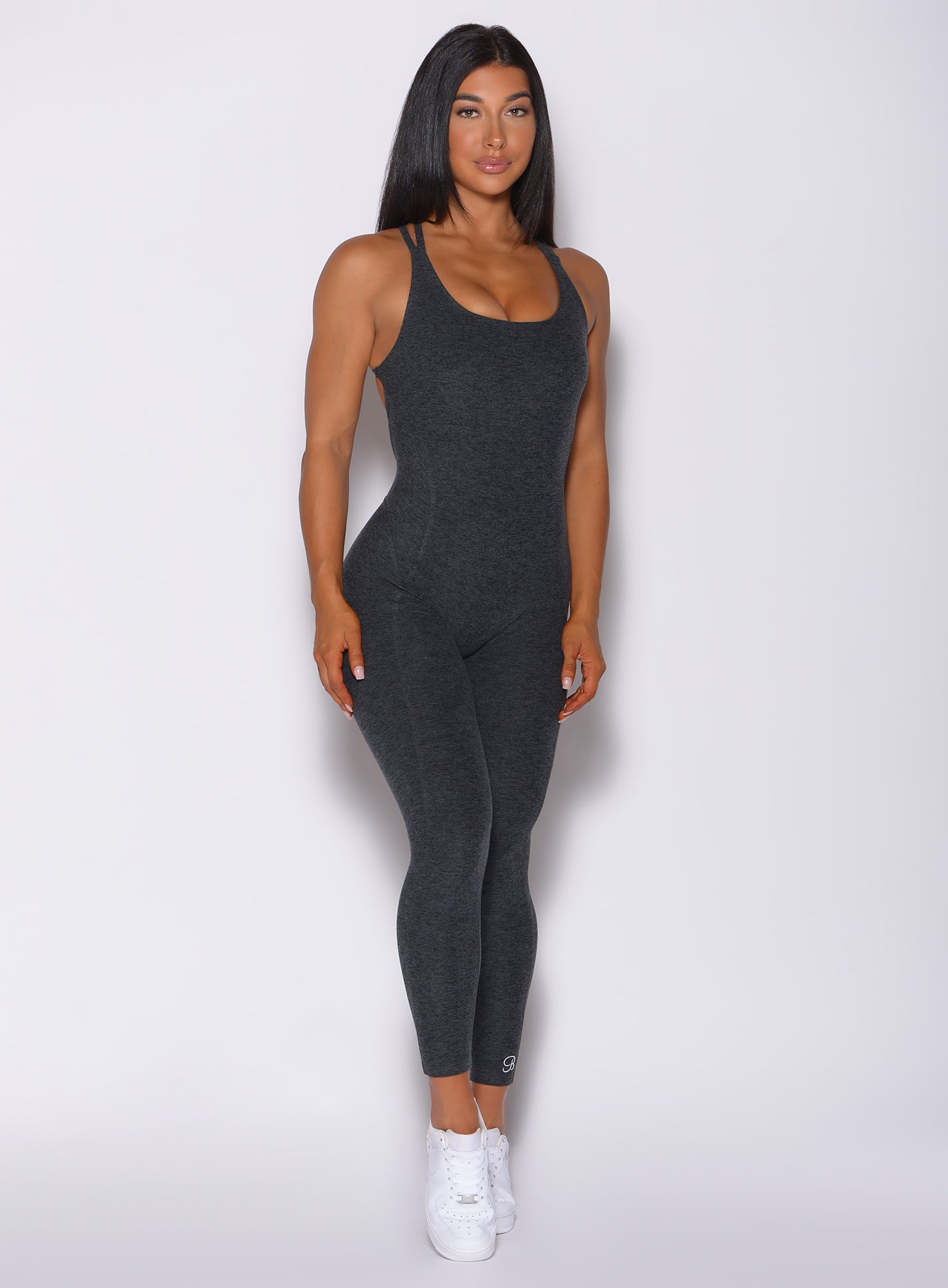 Model facing forward wearing our form bodysuit in charcoal color
