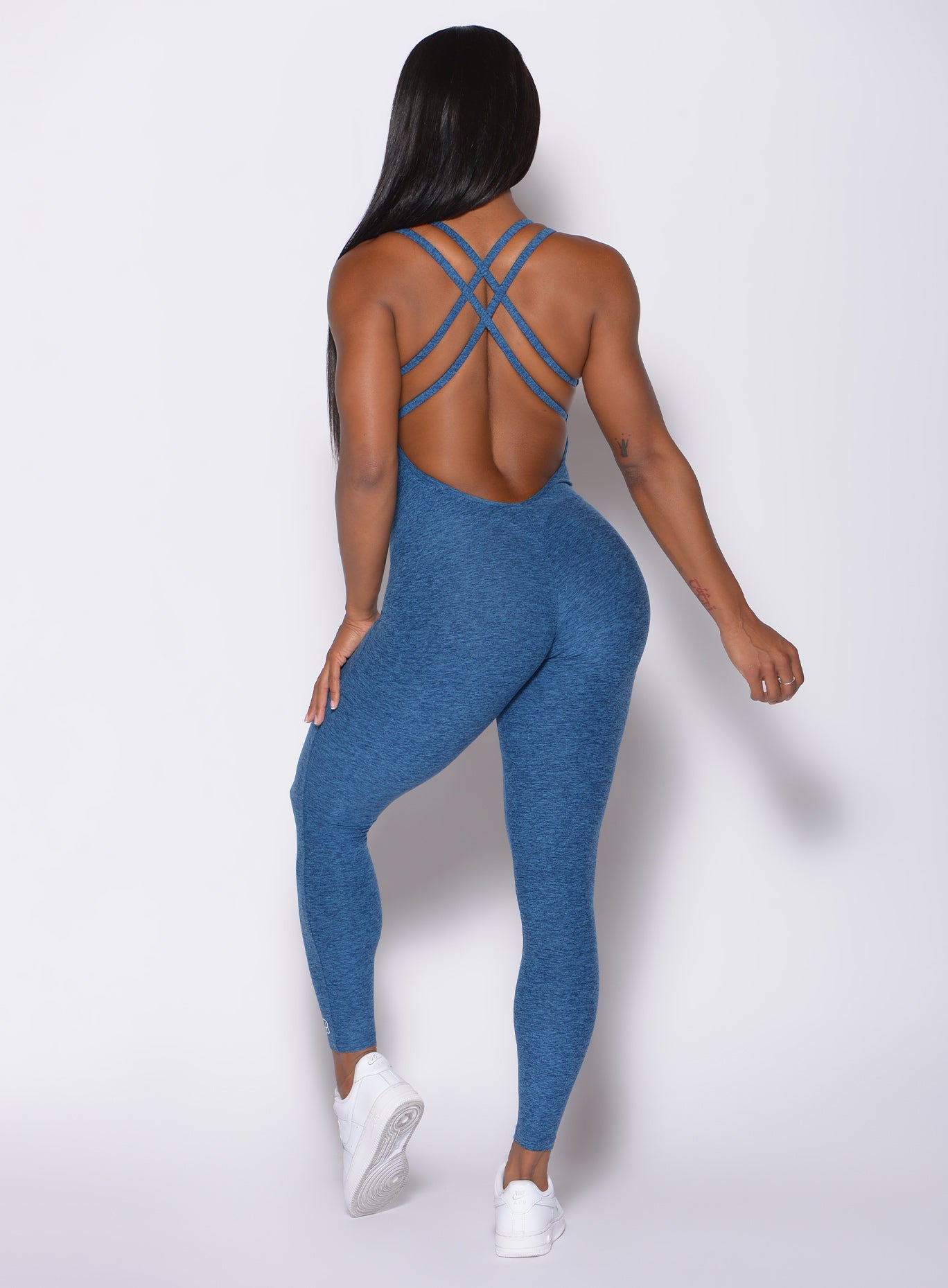 Back profile view of a model in our form bodysuit in ocean color