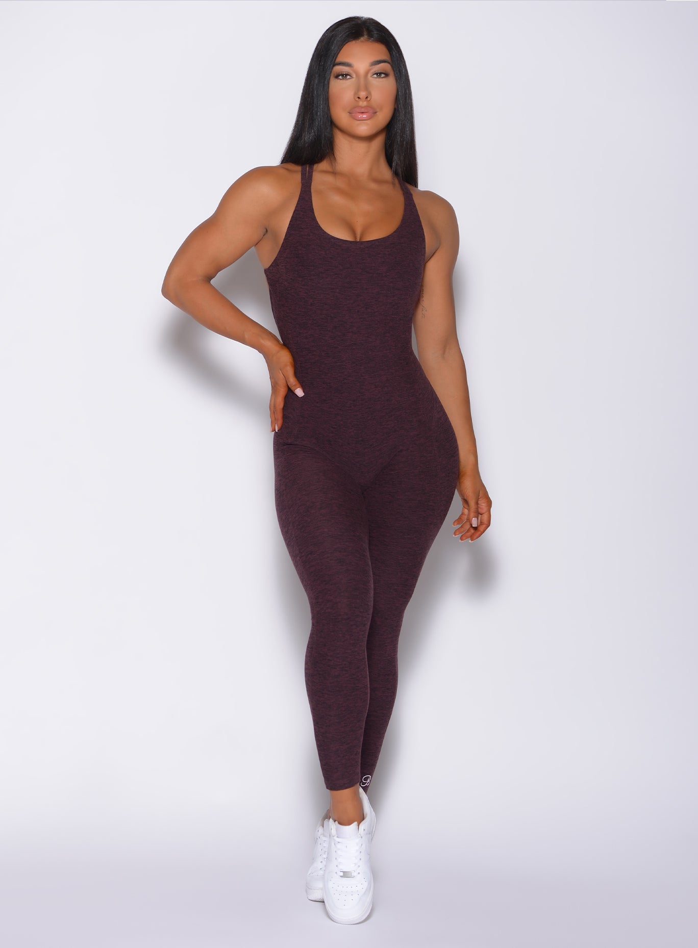 Front profile view of a model in our form bodysuit in port color