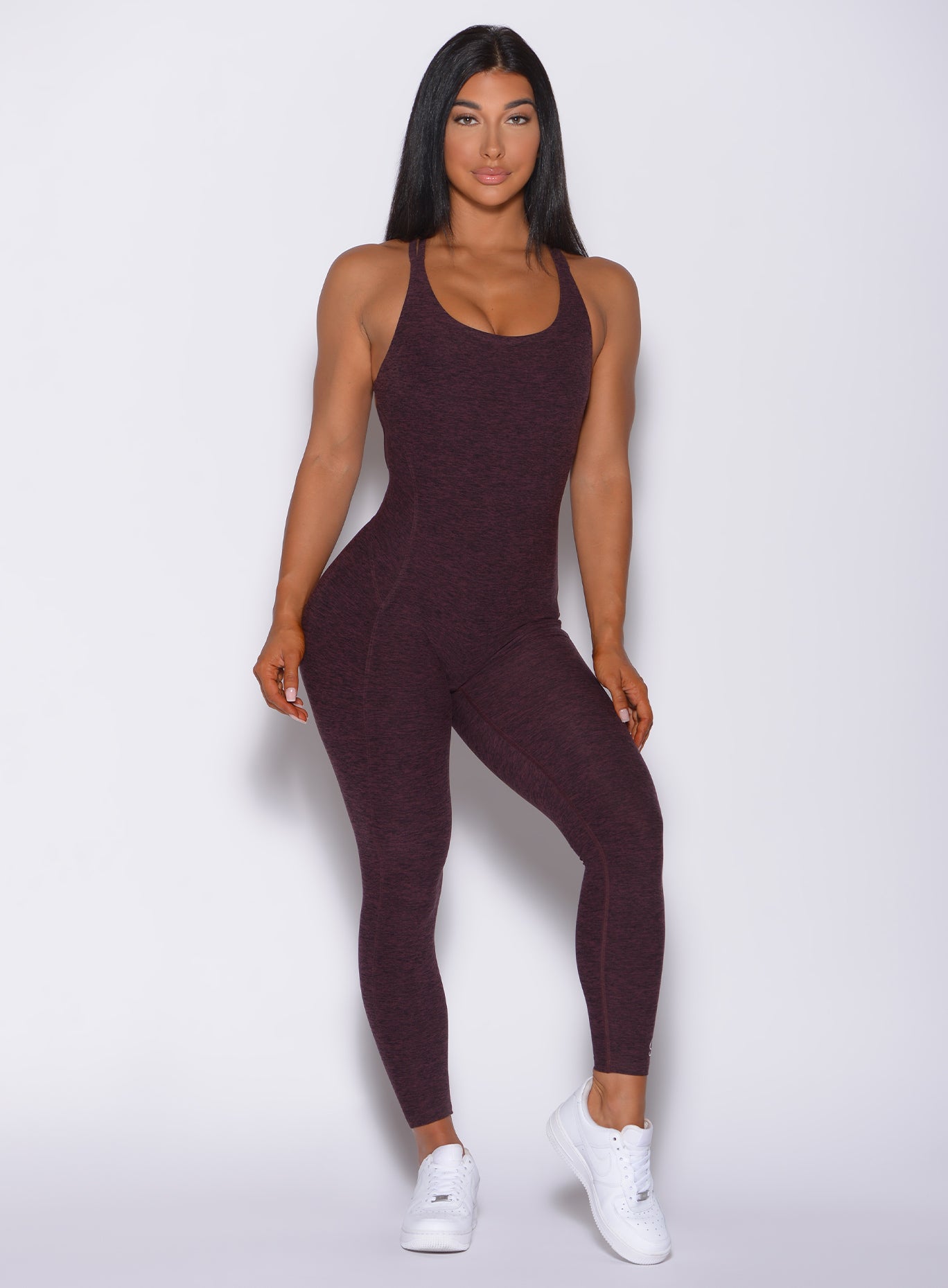 Model facing forward wearing our form bodysuit in port color 