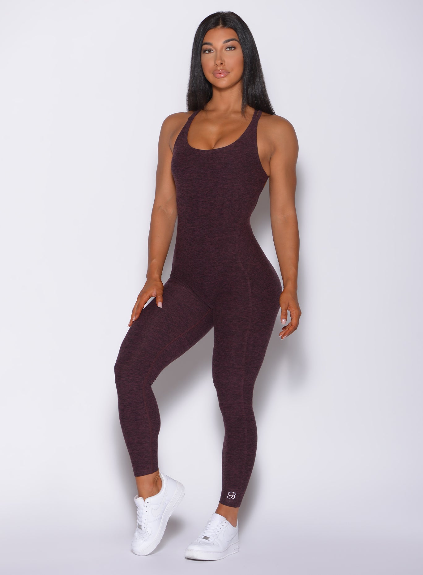 Picture of a model facing forward wearing our form bodysuit in port color 