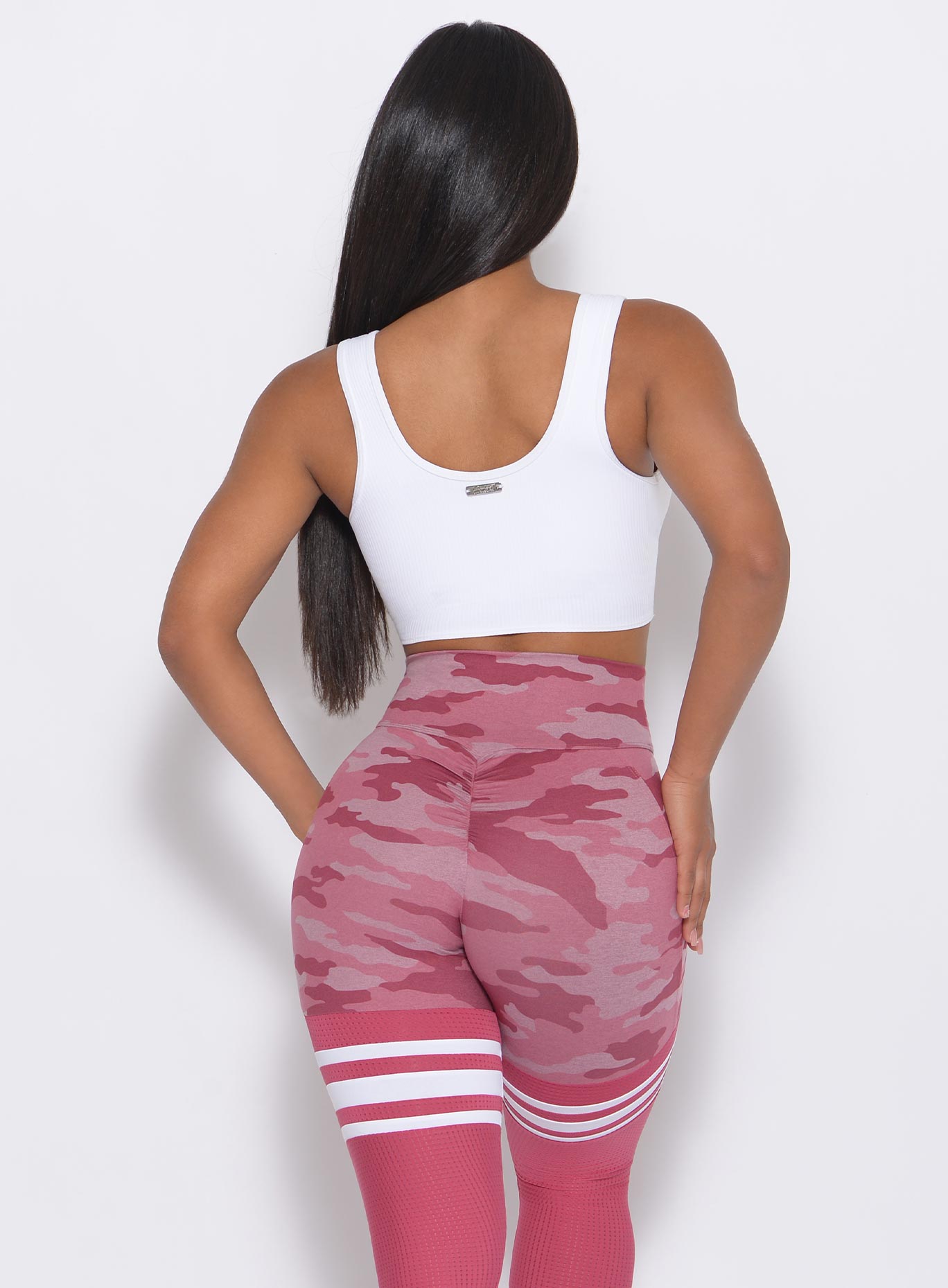 Back view of the model wearing our white Henley Sports Bra and a matching leggings