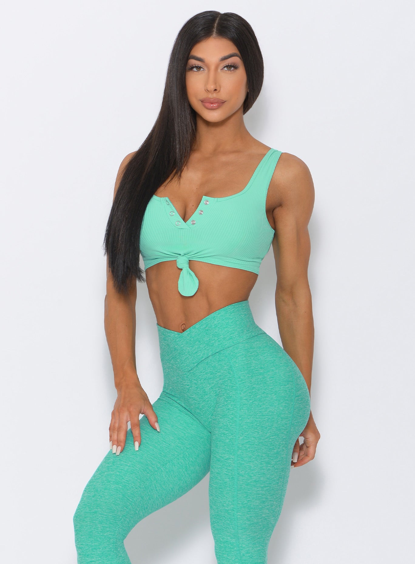 Front profile view of the model in our mint henley sports bra and a matching bra
