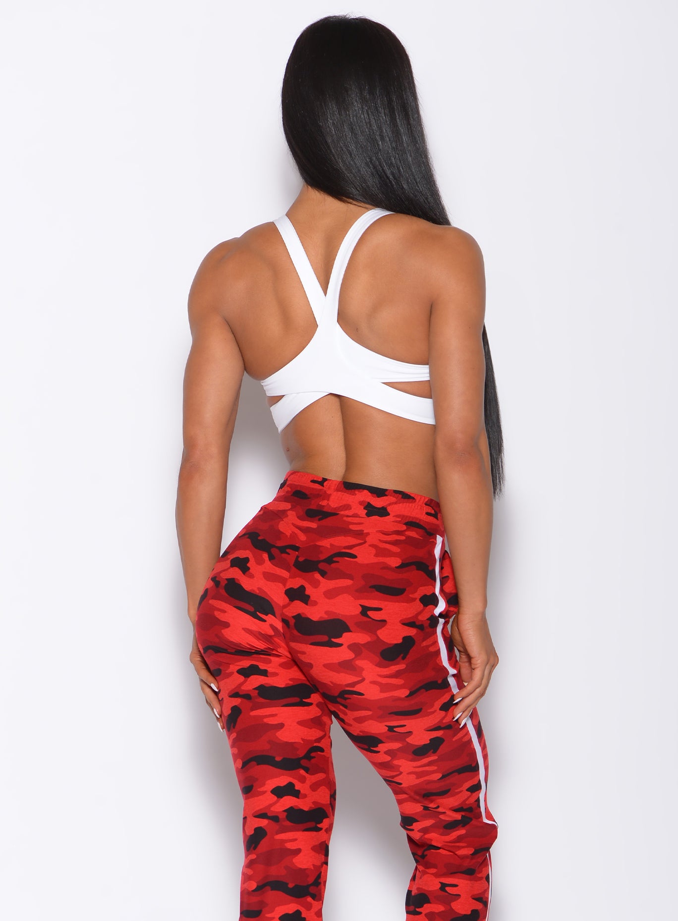 back profile view of a model in our white back it up bra and a red camo joggers 