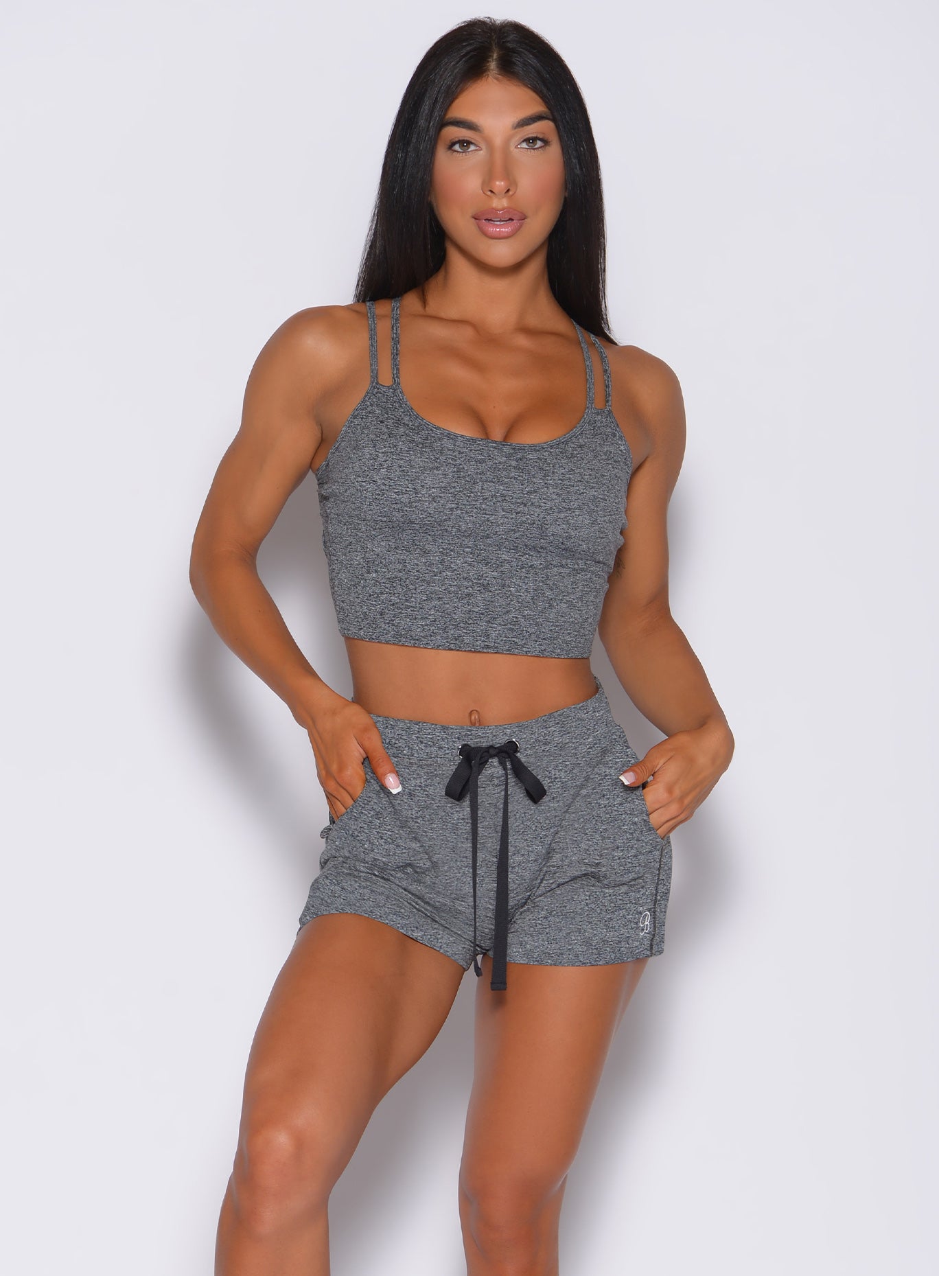 Front profile view of a model in our gray layered back bra and a matching shorts 