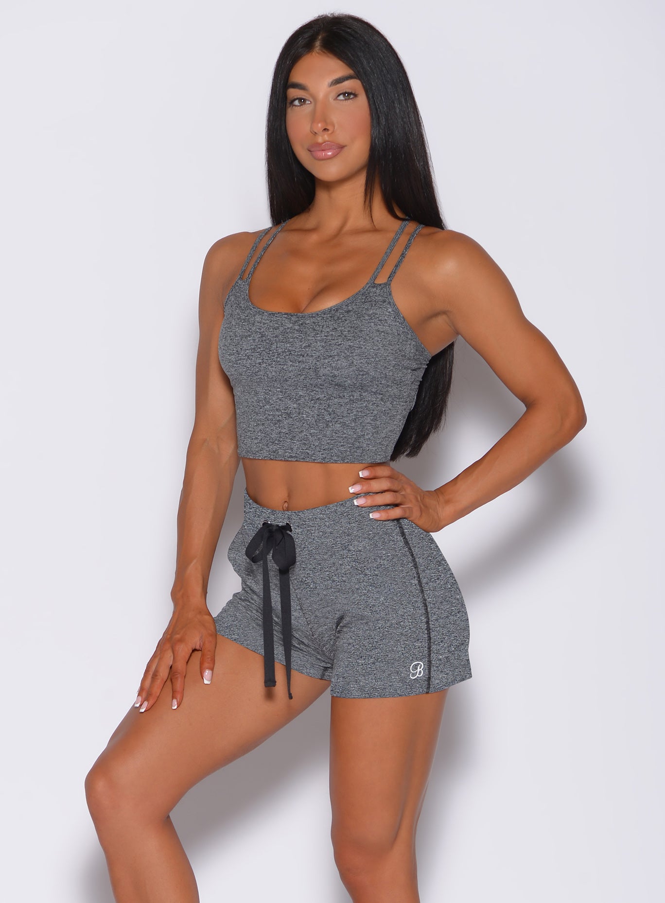 Front profile view of a model wearing our gray layered back bra and a matching shorts