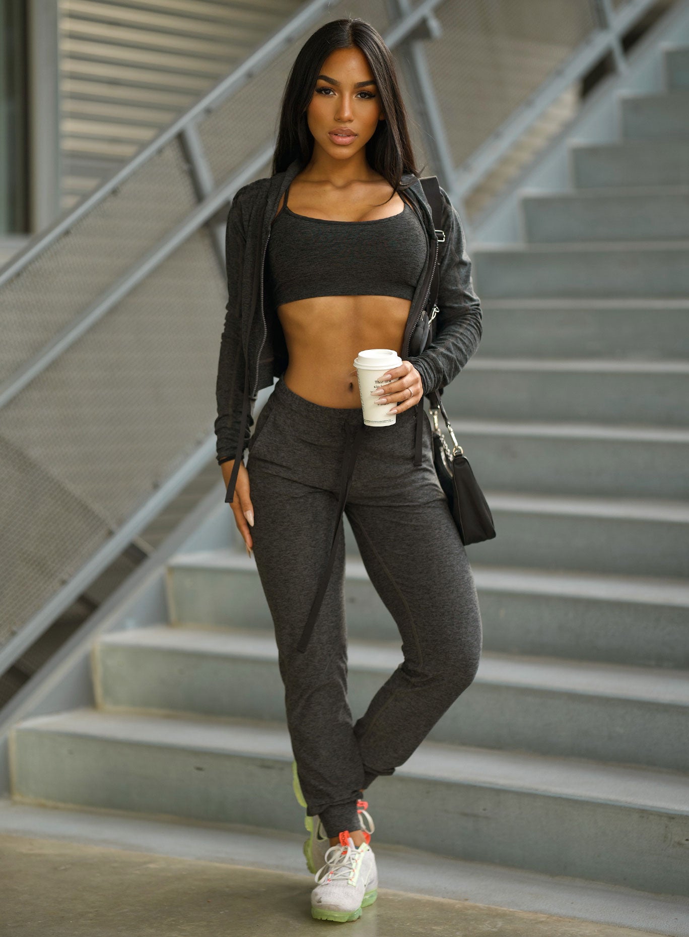Front profile view of the model wearing our cozy joggers in charcoal color 