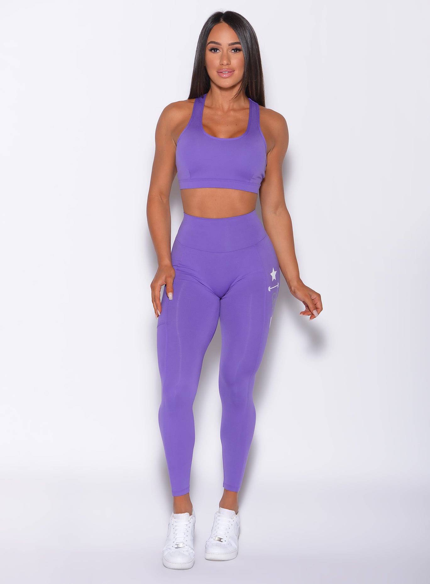 Front view of model wearing our killing it leggings and scull crusher sports bra in royal purple
