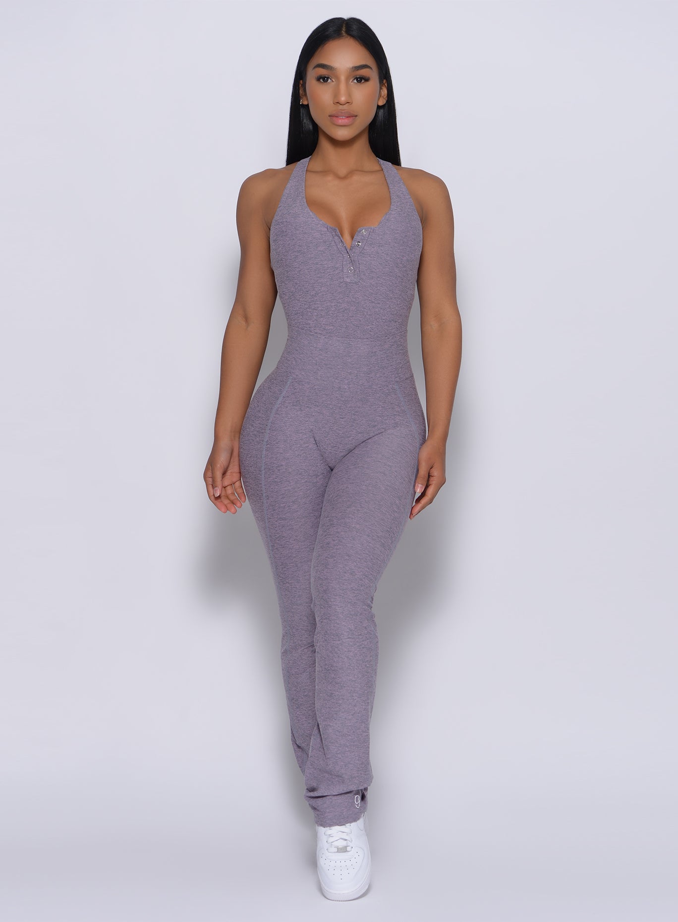 Front profile view view of a model facing forward wearing our straight up leggings in orchid color and a matching bodysuit