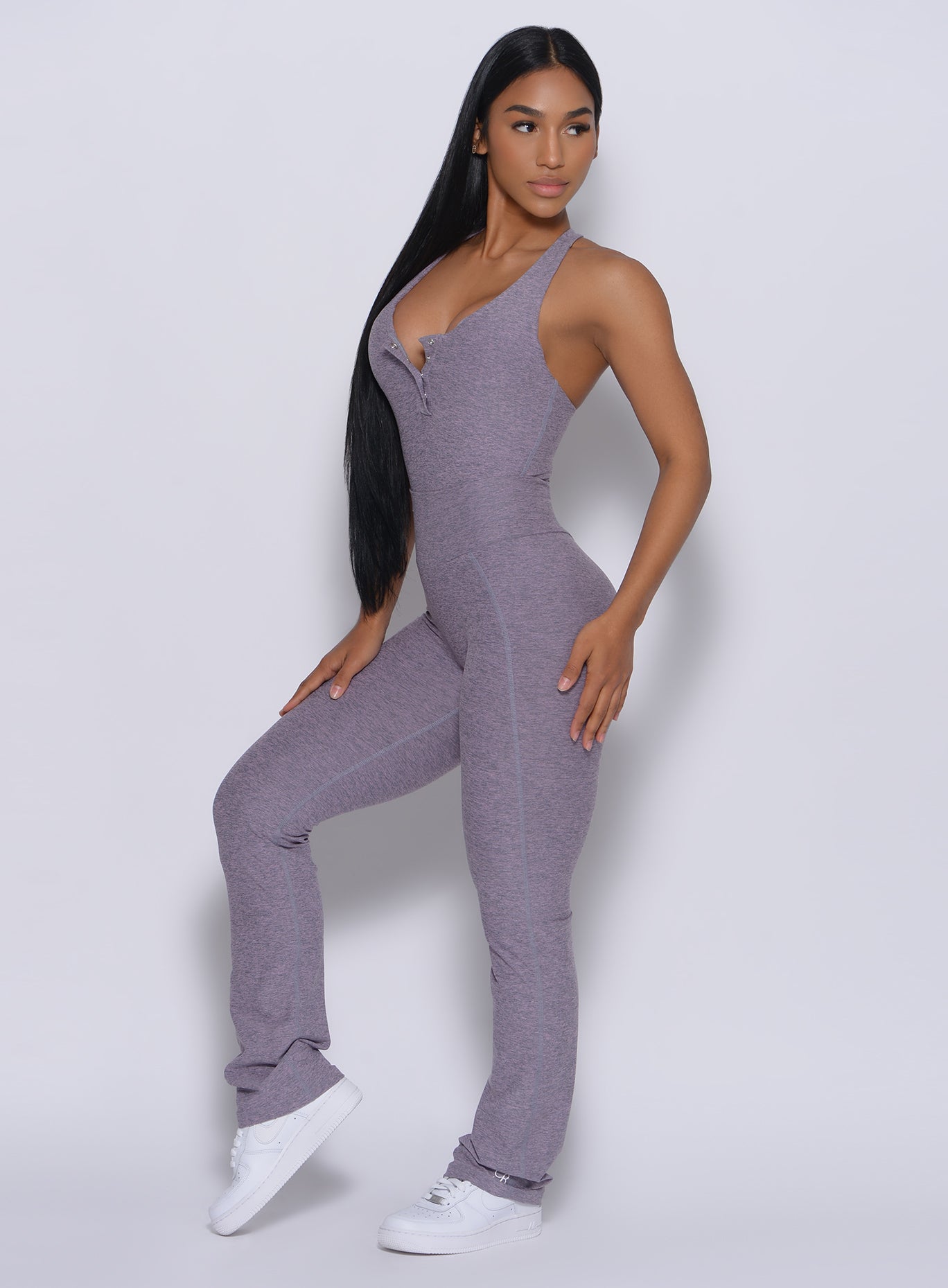 Left side profile view of a model angled left wearing our straight up leggings in orchid color and a matching bodysuit