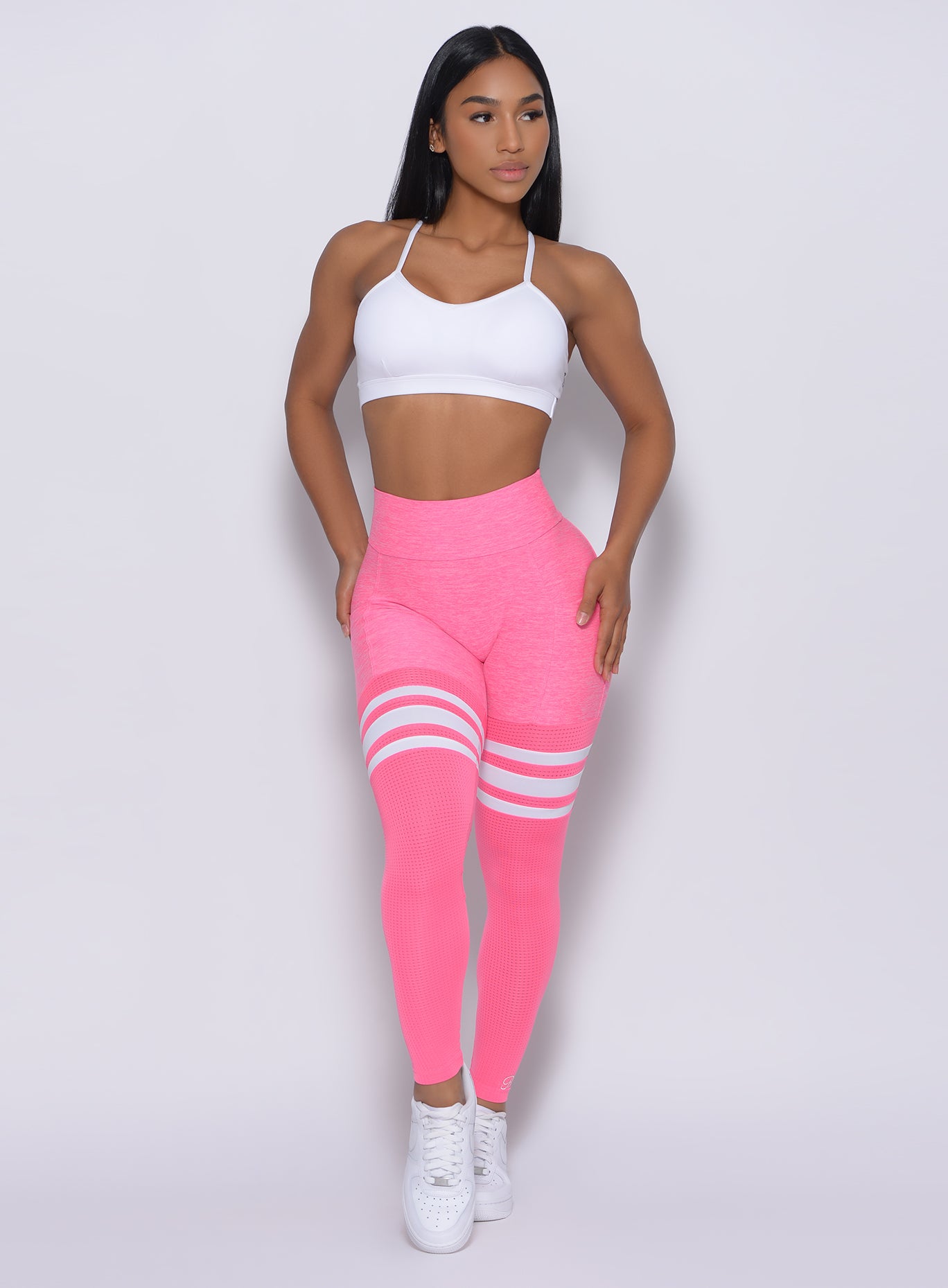 White Pumped Sports Bra paired with Hollywood Pink Scrunch Thigh High Leggings for a gym-ready fit.