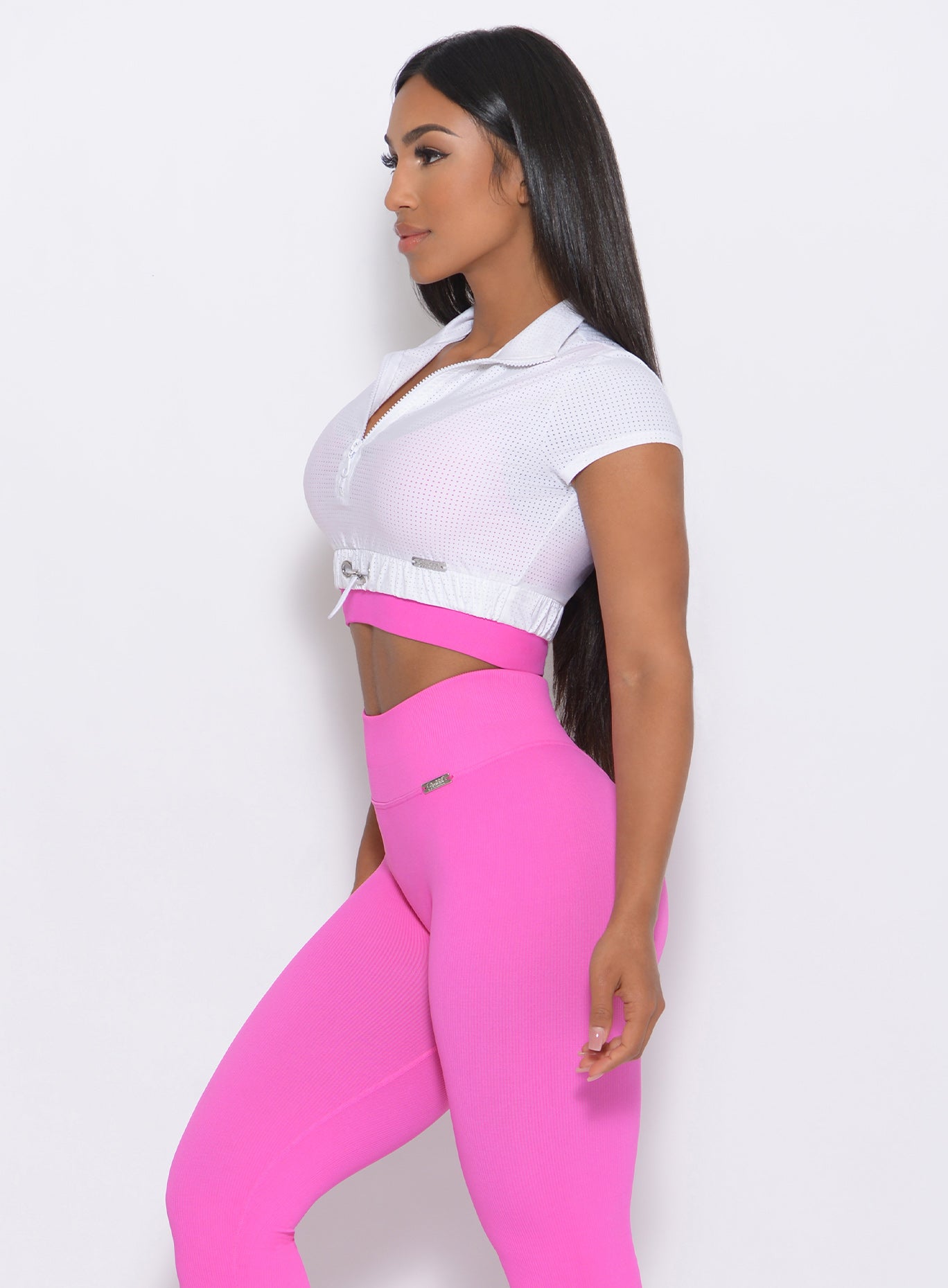 Left side view of the model in our white glow up top and a pink leggings