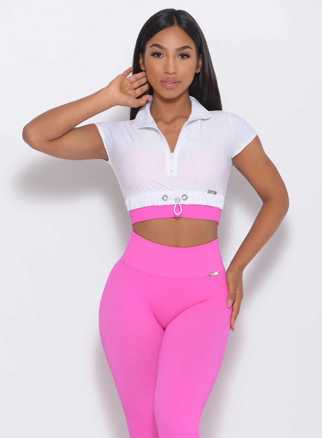 Front view of the model in our white glow up top and a pink leggings