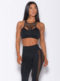 Model facing forward wearing our black Attitude Sports Bra and a matching mohawk leggings