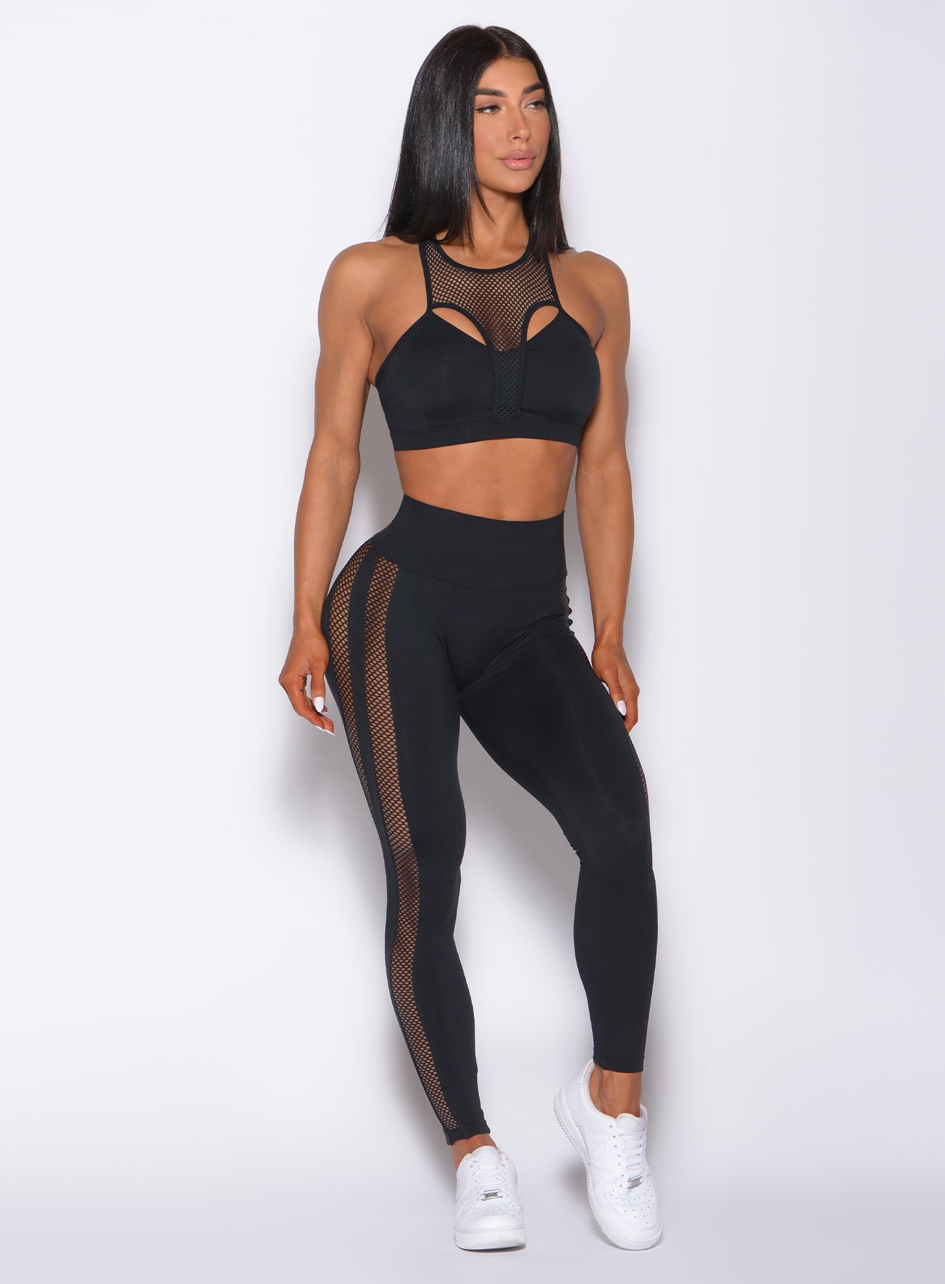 Model facing forward wearing our black mohawk leggings and a matching sports bra 
