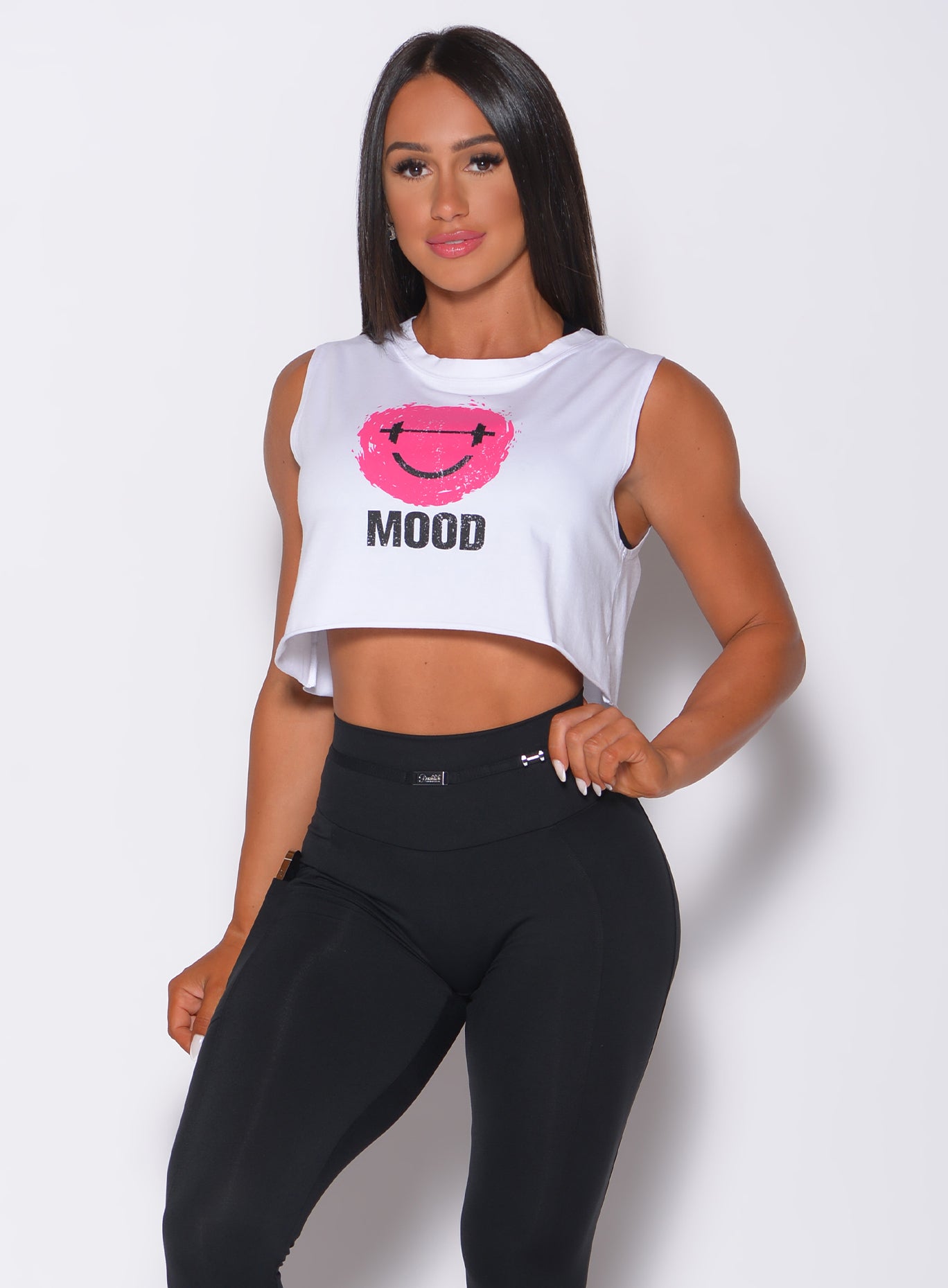 Front profile view of a model in our white mood tank and a black leggings 