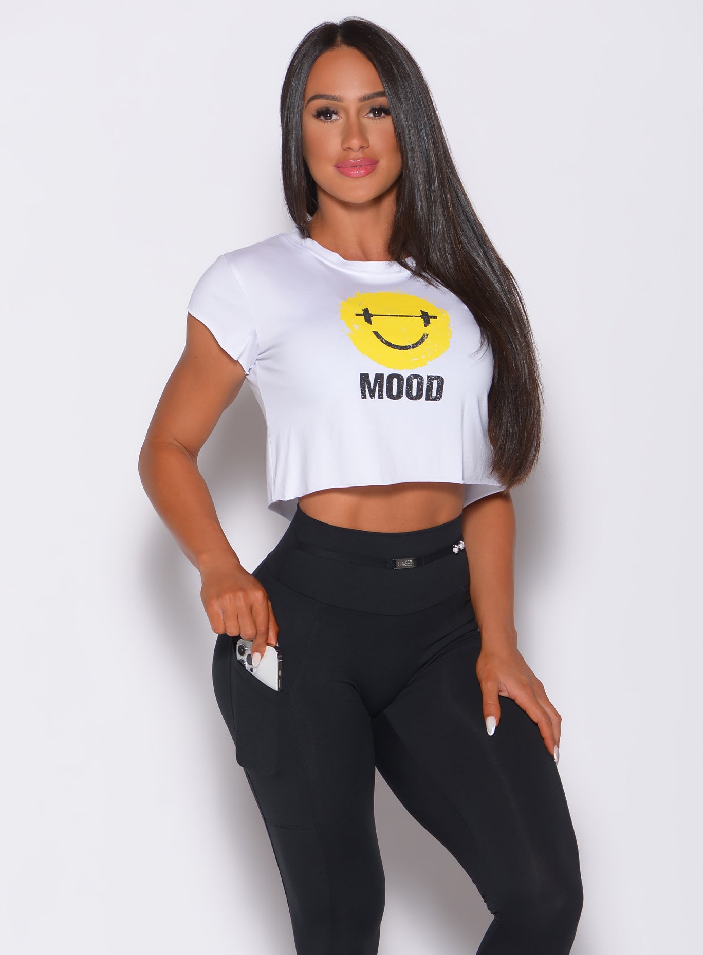 Front profile view of a model in our white mood tee and a black leggings