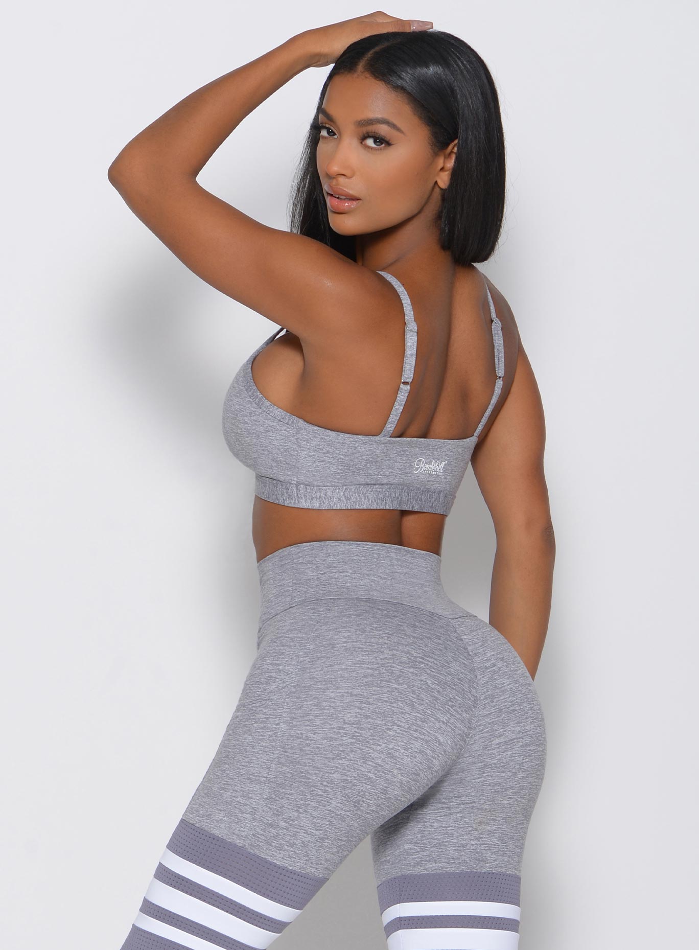 Back view of the model in a gray sports bra 