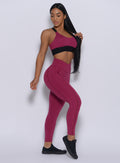 Right side view of the model angled right wearing our Brazilian leggings in mulberry color and a matching bra