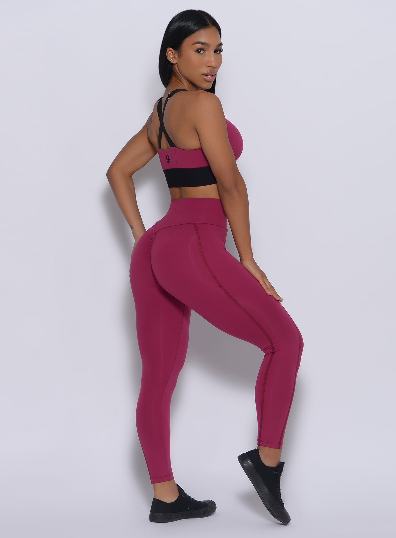 back side view of the model wearing our Brazilian leggings in mulberry color and a matching bra