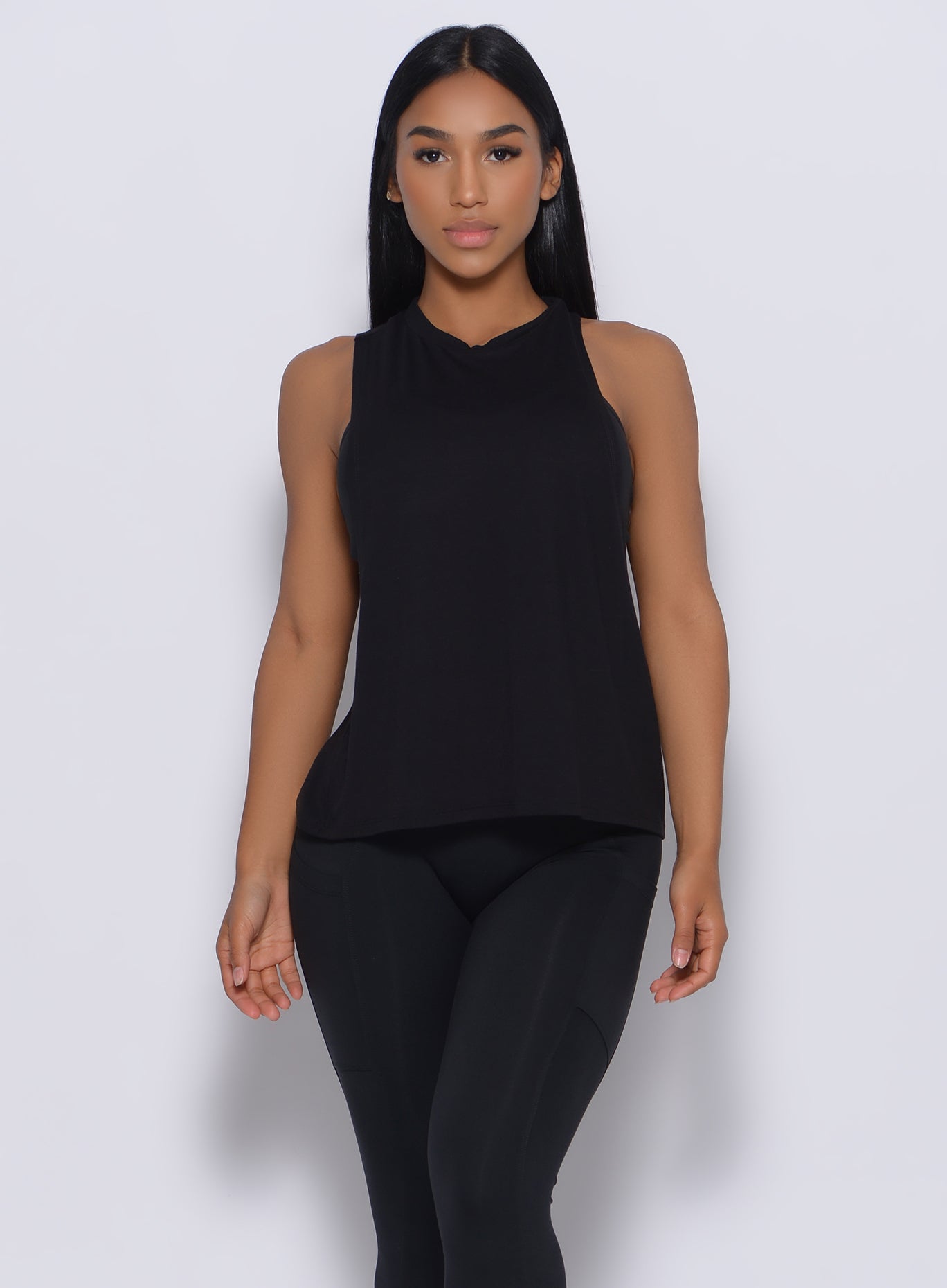 Front profile view of a model in our black muscle tank and a matching leggings