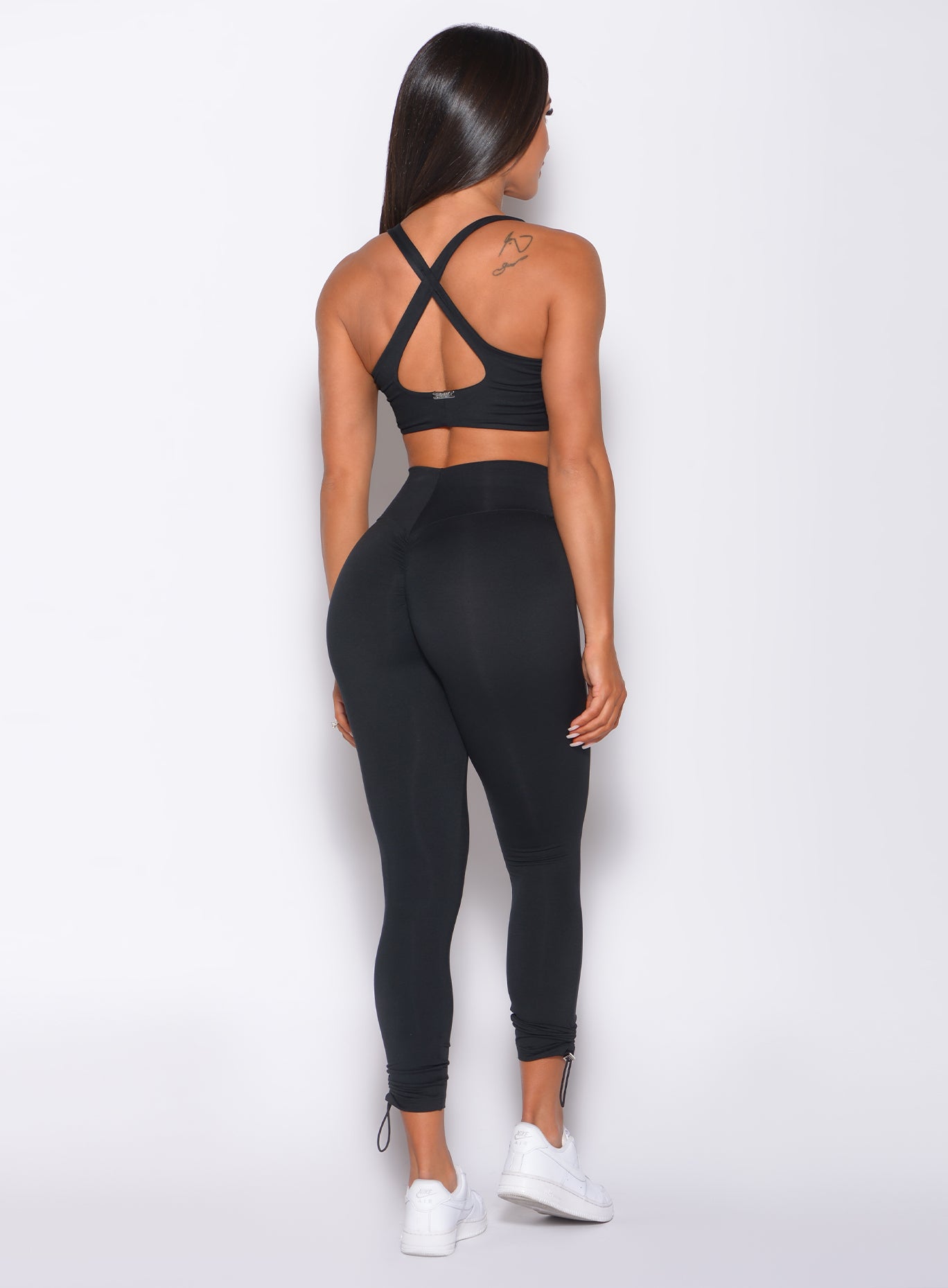 Sculpting black Contour Toggle Leggings with an adjustable V-cut waist for a custom gym fit.