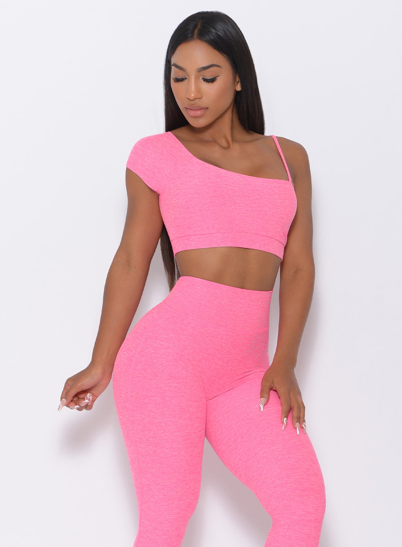 Front view of the model wearing our Adore Sports Bra in pink and a matching leggings