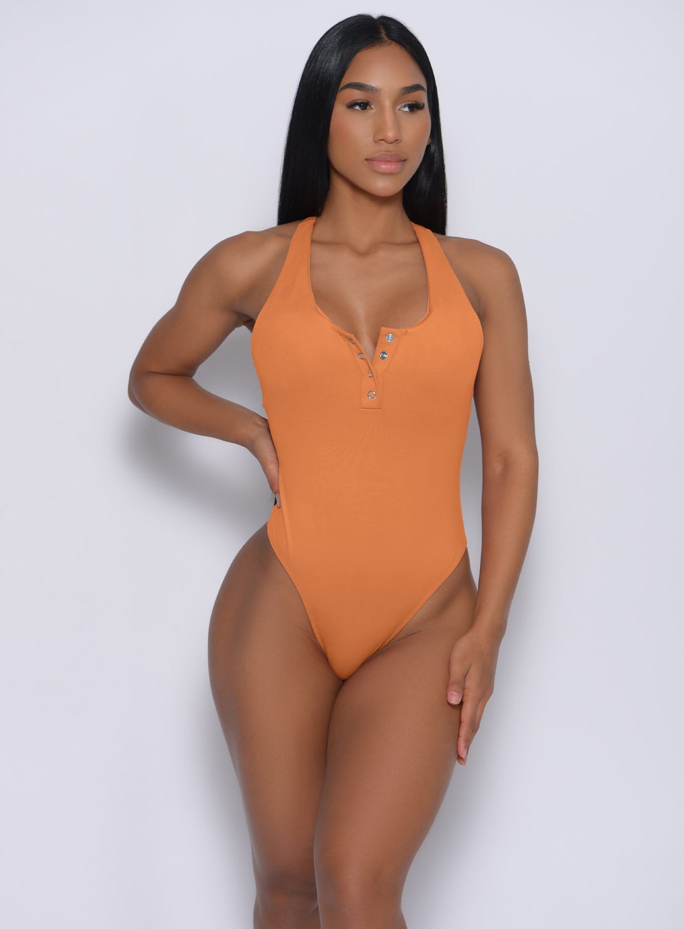 Front profile view of a model wearing  our perfect bodysuit in honeycomb color 