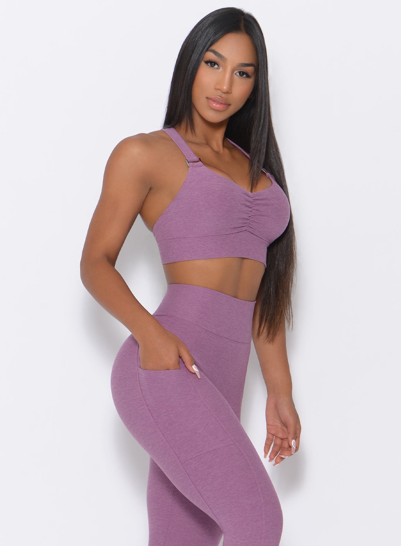 Right side view of the model wearing our perfection sports bra in lavender and a matching leggigs