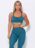 Front view of the model  wearing our perfection sports bra in seafoam color and a matching leggings