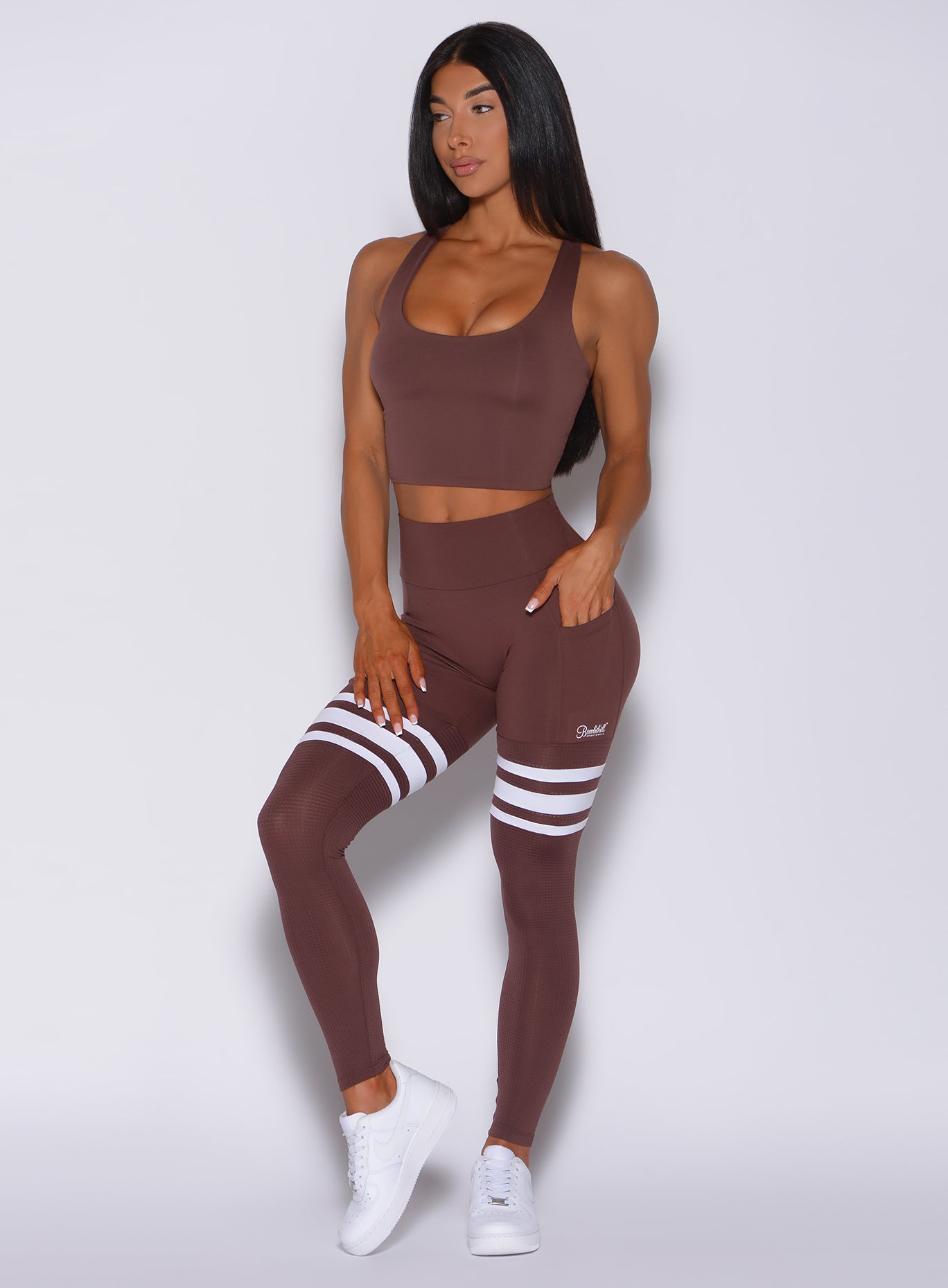 Front  profile view of a model wearing our perform thigh high in chocolate color and a matching bra