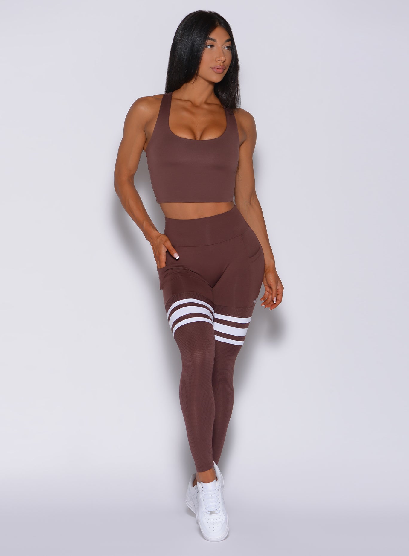 Front profile view of a model in our perform thigh high in chocolate color and a matching bra 