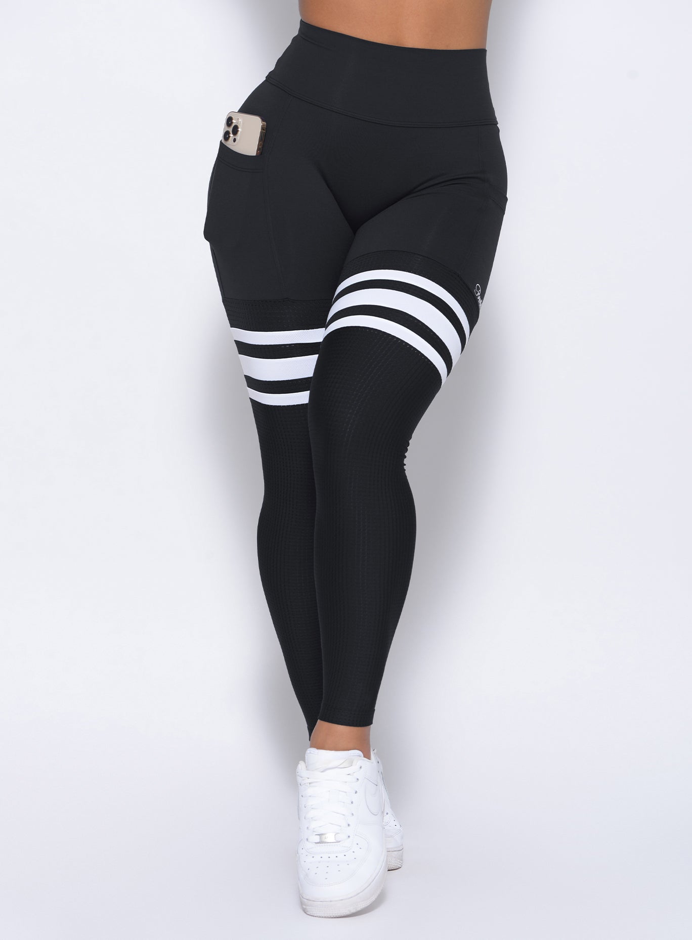 Zoomed in front view of our black perform thigh high leggings