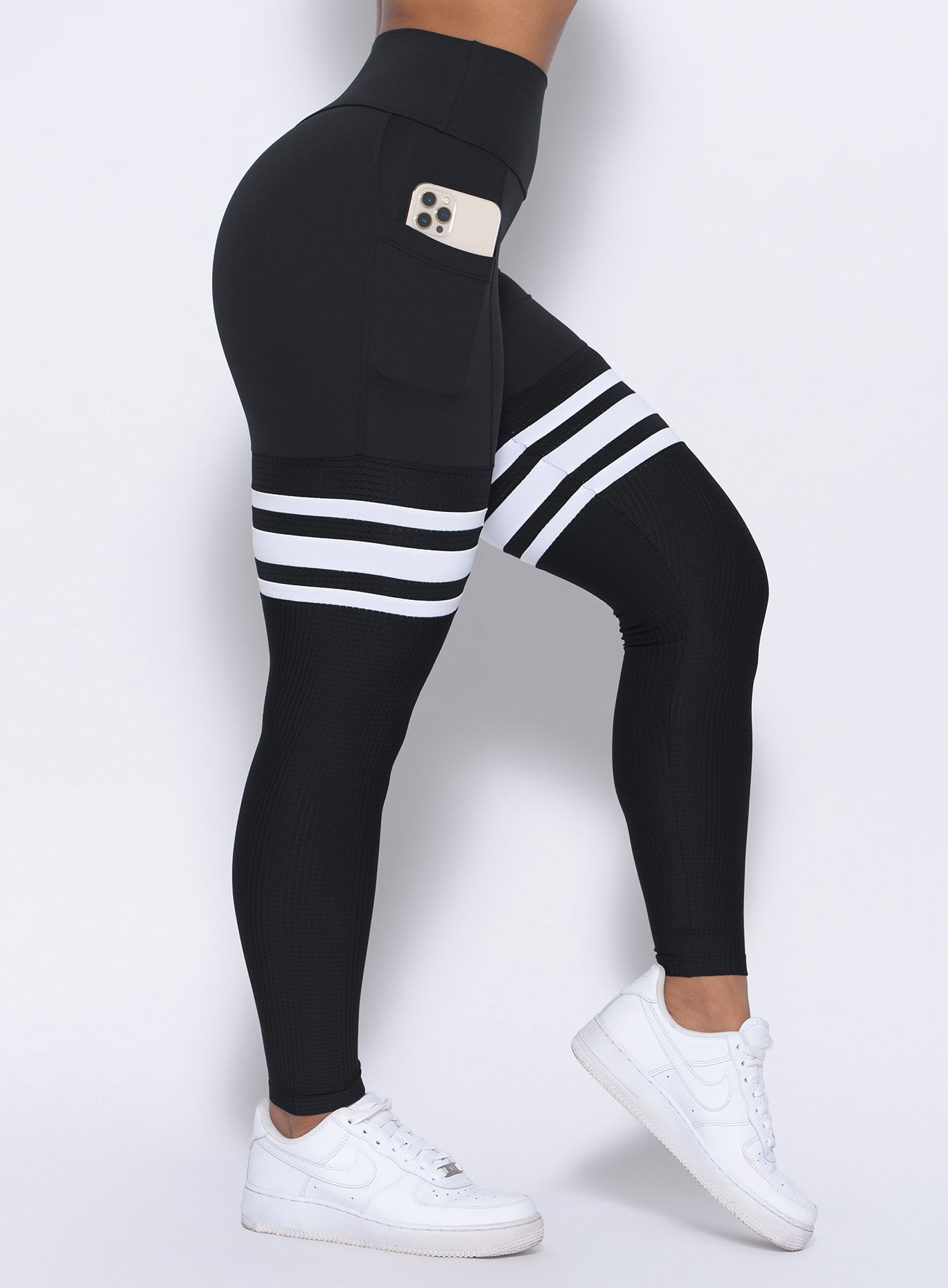 Zoomed in right side view of our black perform thigh high leggings