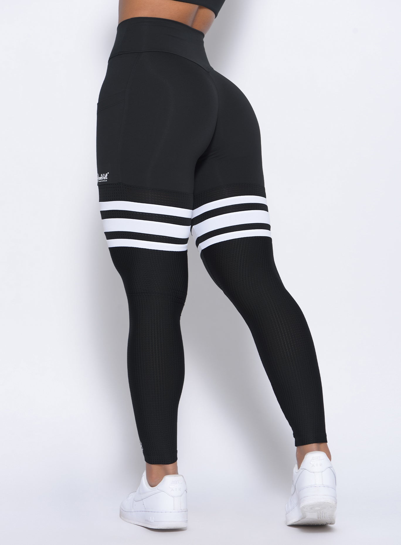 Zoomed in back view of our black perform thigh high leggings
