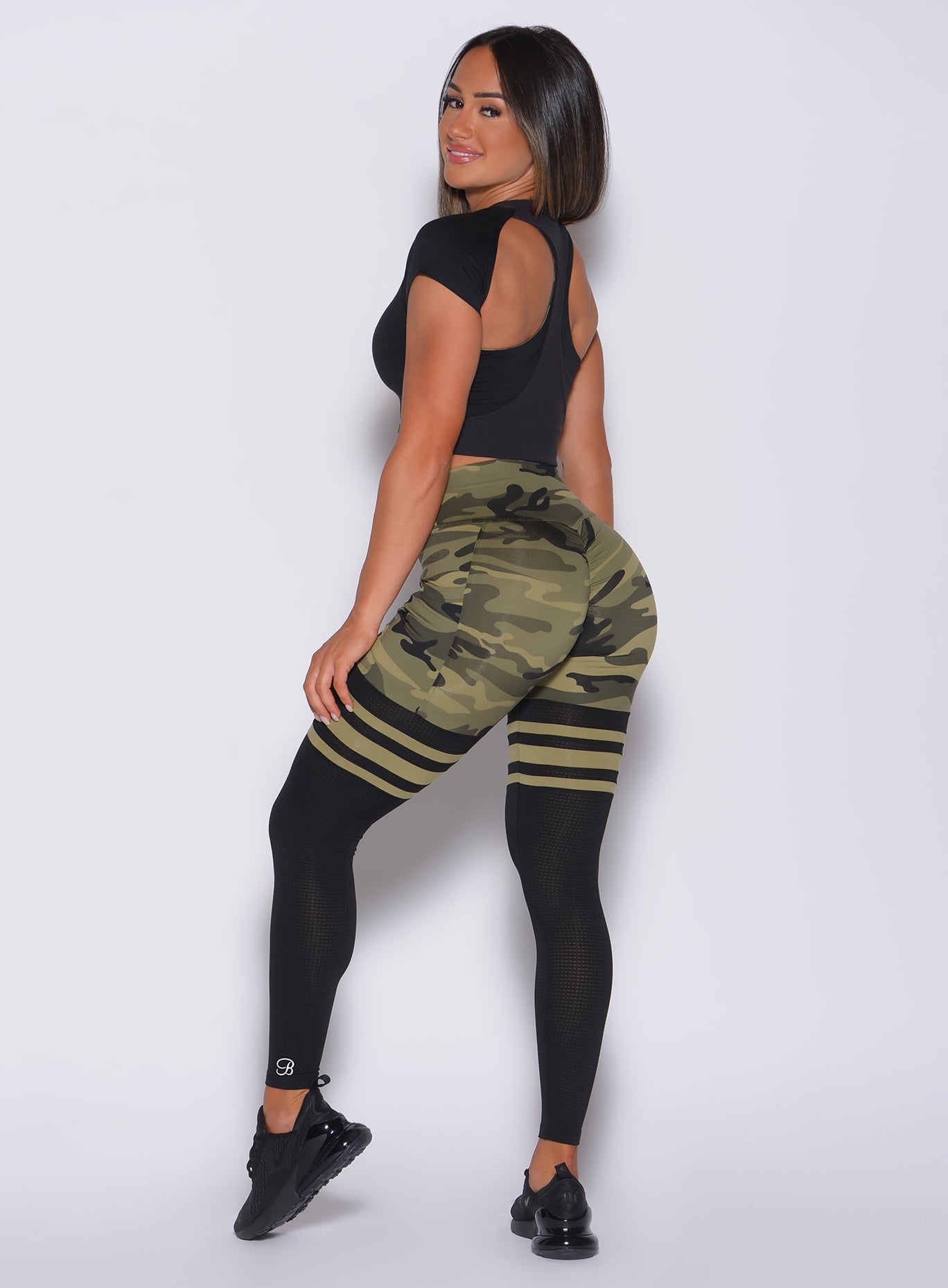 Green Camo Scrunch Thigh-Highs with mesh panels and side pockets for a sculpted gym look.