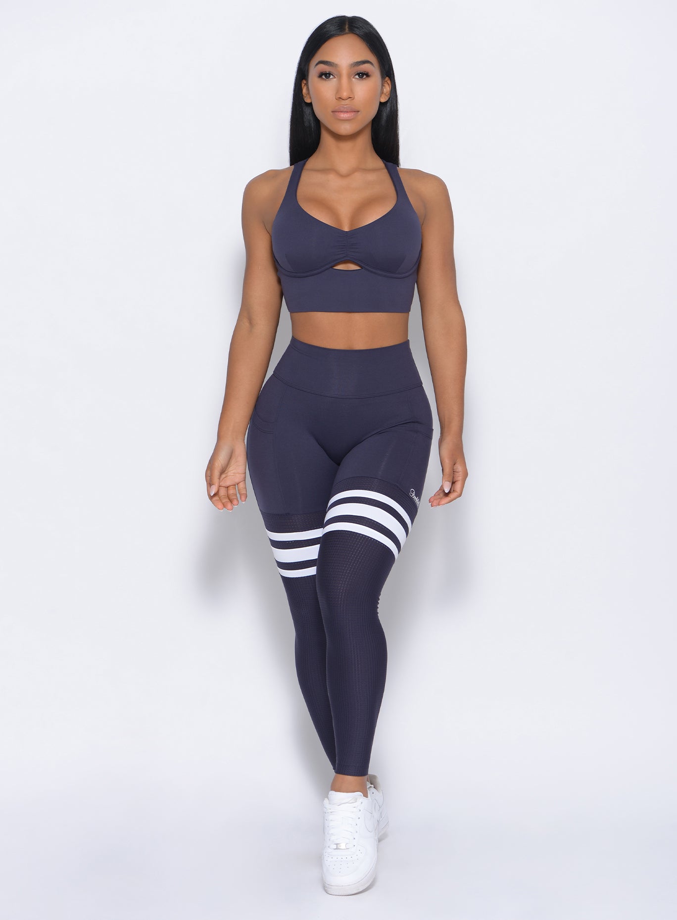 Model facing forward in our keyhole bralette in twilight blue color and a matching leggings