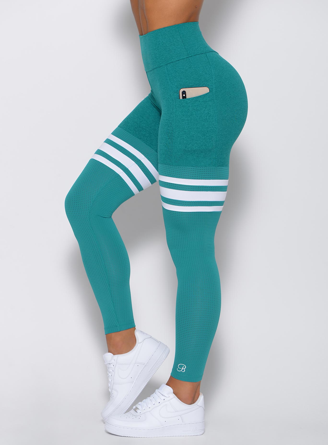 Side angle photo of Thigh High High waist leggings with iPhone in pocket