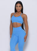 Model facing forward wearing our pumped sports bra in blazing blue color and a matching leggings 
