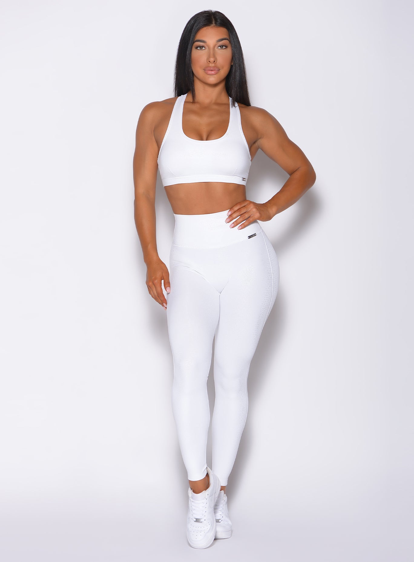 Model facing forward wearing our shine leggings set in white python color 