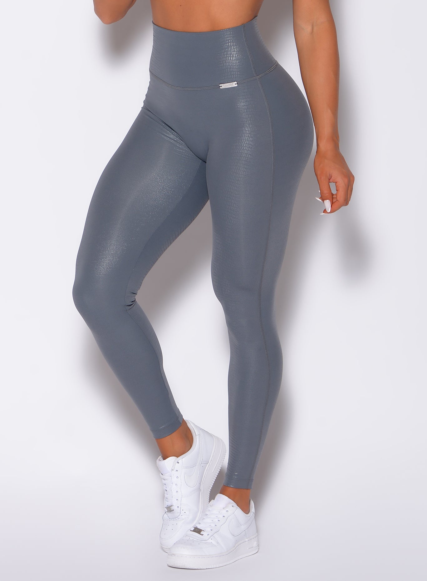 Zoomed in front view of our shine leggings in gray python color 