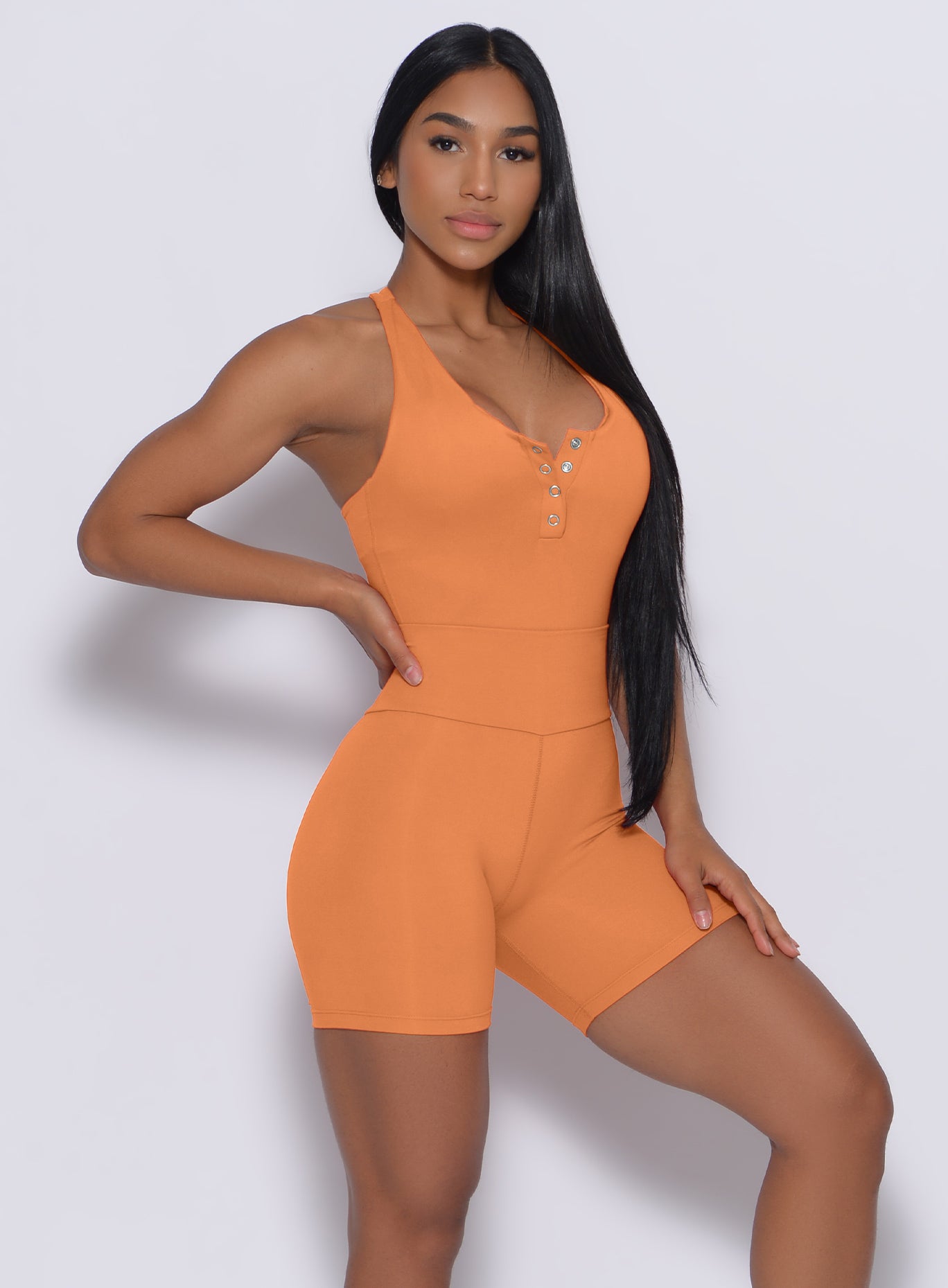 Right side profile view of a model angled right wearing our refined shorts in honeycomb color and a matching bodysuit