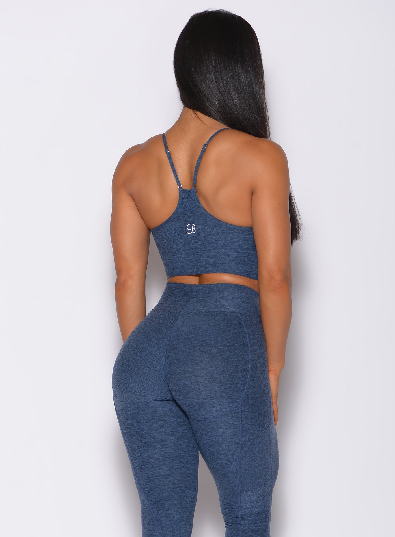 Back profile view of a model in our relax long bra in night sky color and a matching leggings
