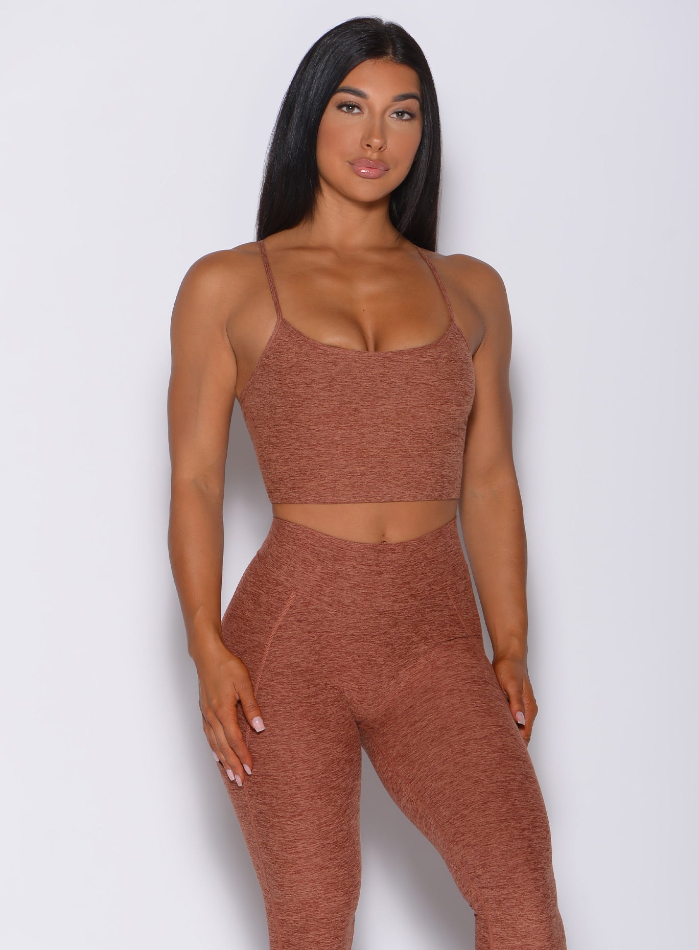 Front profile view of a model wearing our relax long bra in spiced chai color and a matching leggings