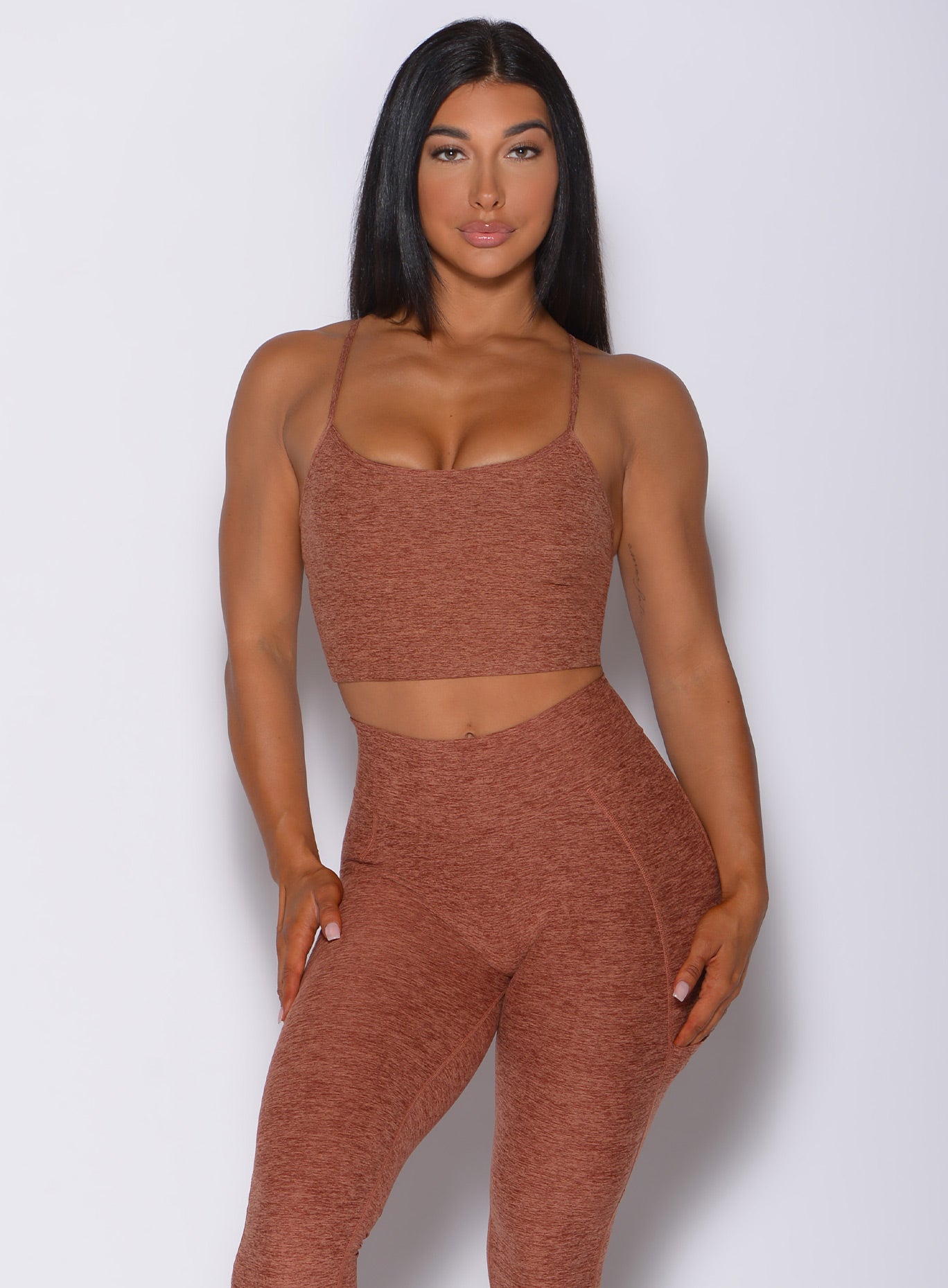 Front profile view of a model in our relax long bra in spiced chai color and a matching leggings