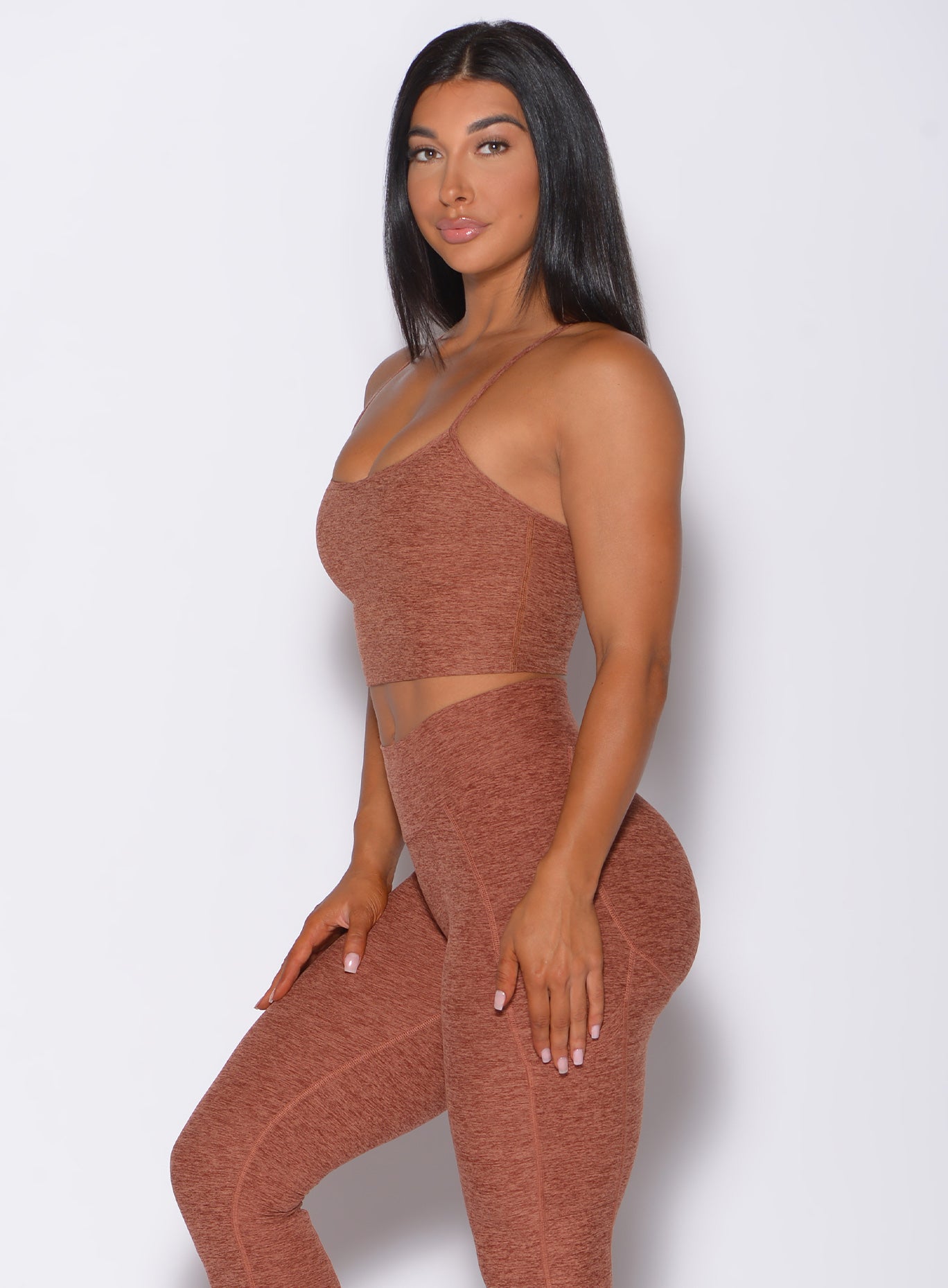 Left side profile view of a model angled left wearing our relax long bra in spiced chai color and a matching leggings