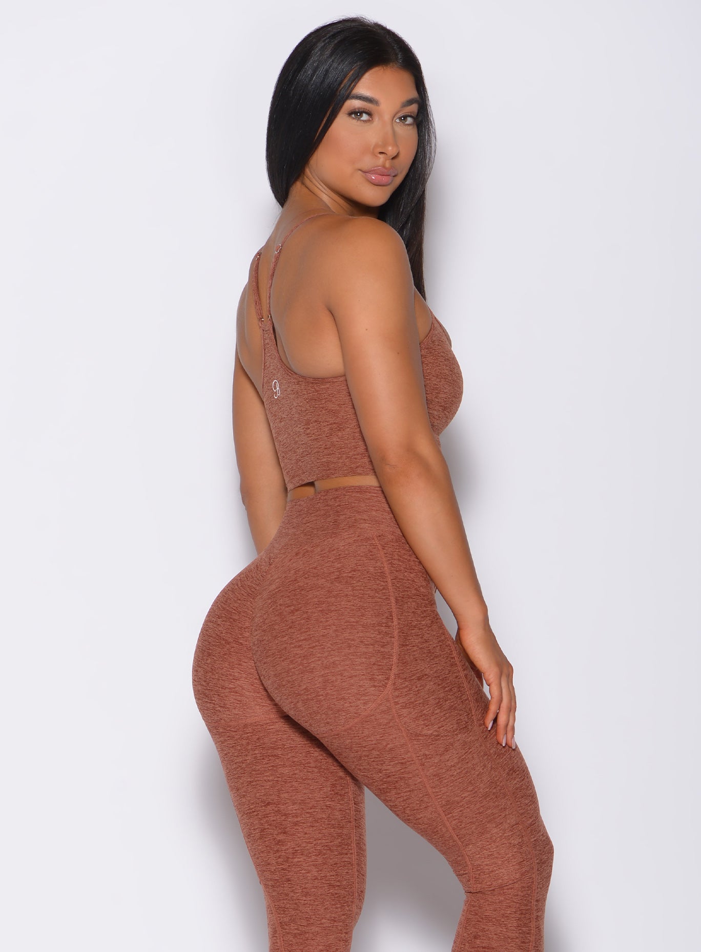 Right side profile view of a model in our relax long bra in spiced chai color and a matching leggings